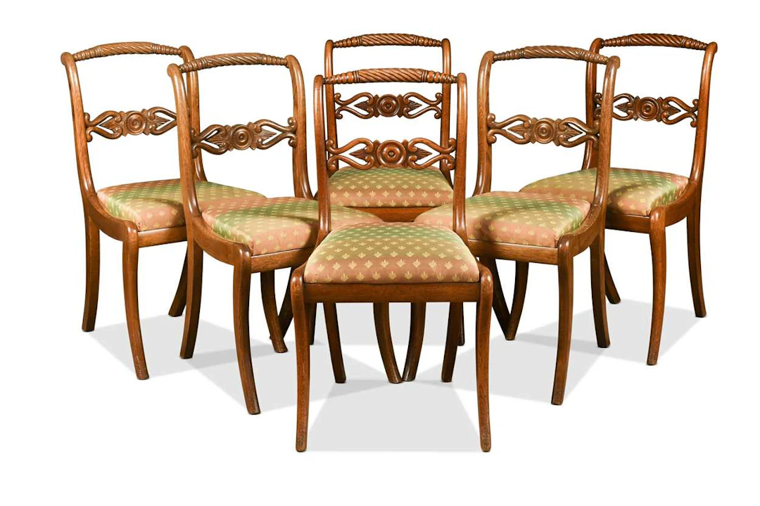 A set of six Regency oak single dining chairs