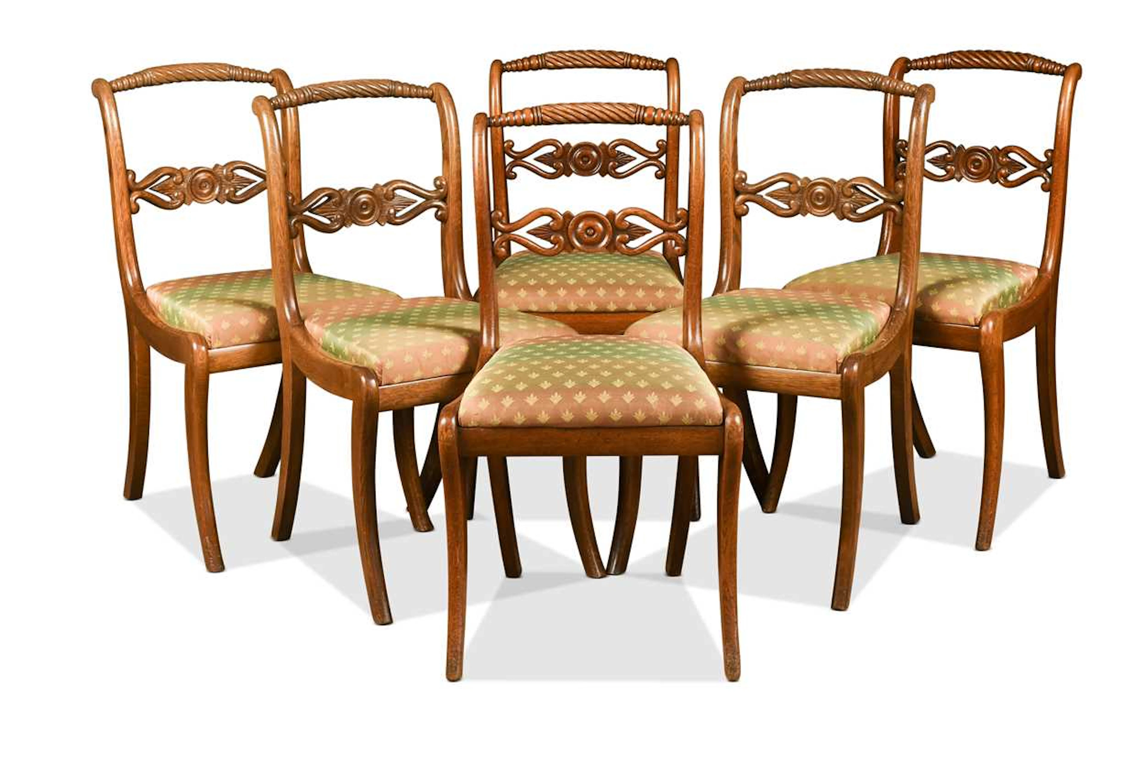 A set of six Regency oak single dining chairs