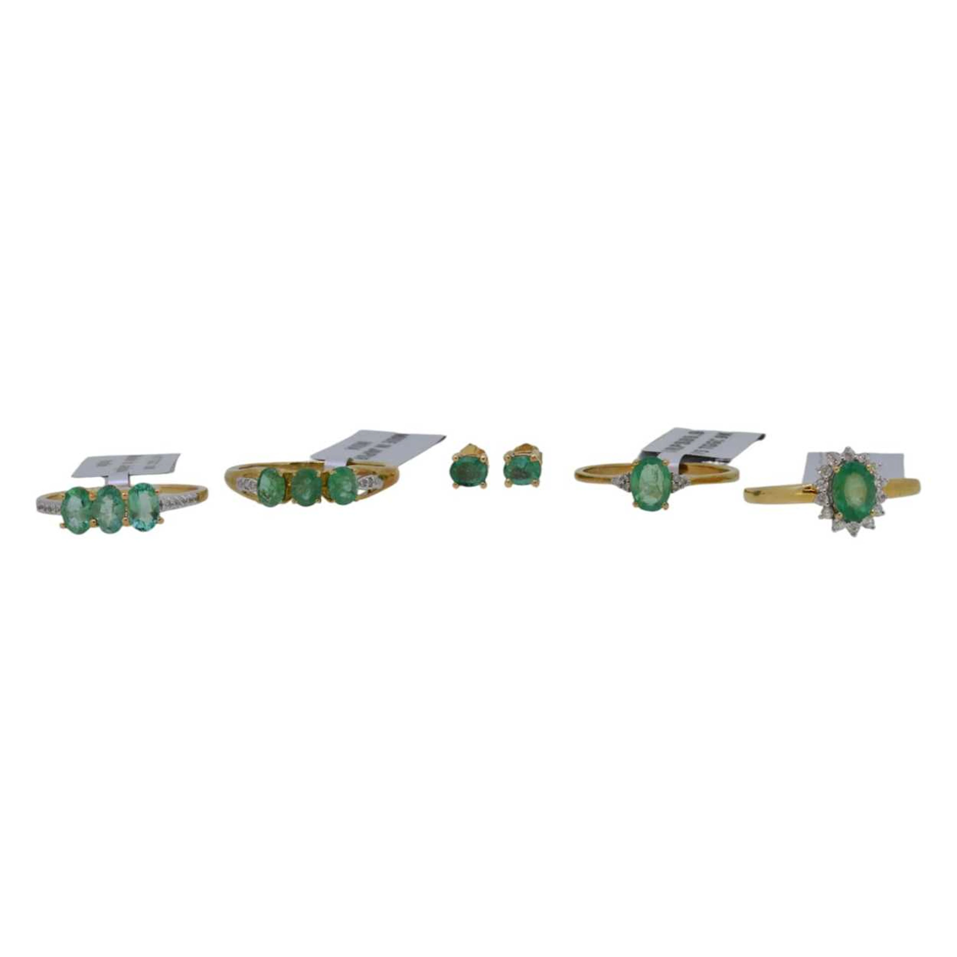 A group of four emerald rings, together with a pair of ear studs