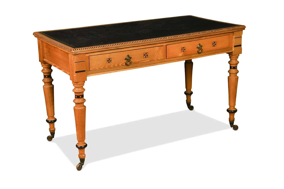 An Arts & Crafts leather inset ash library table