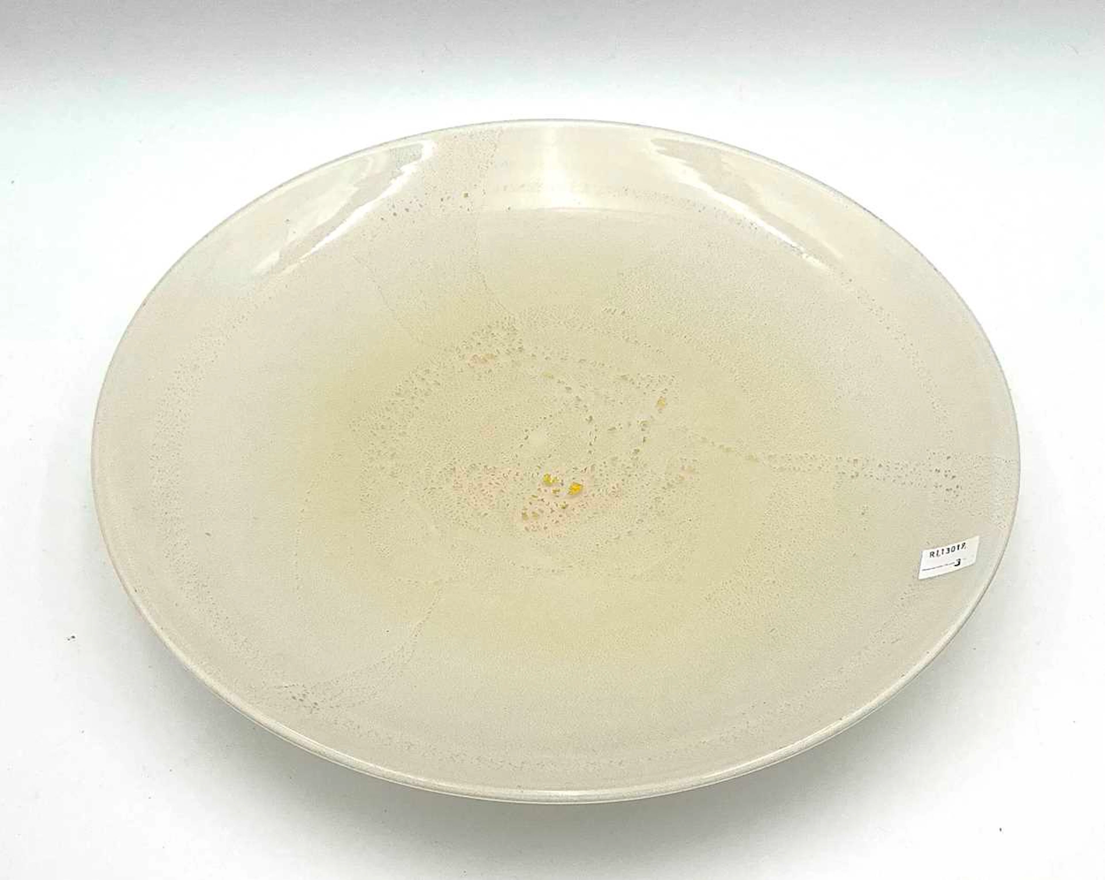 A large opalescent glass charger with gold flecks