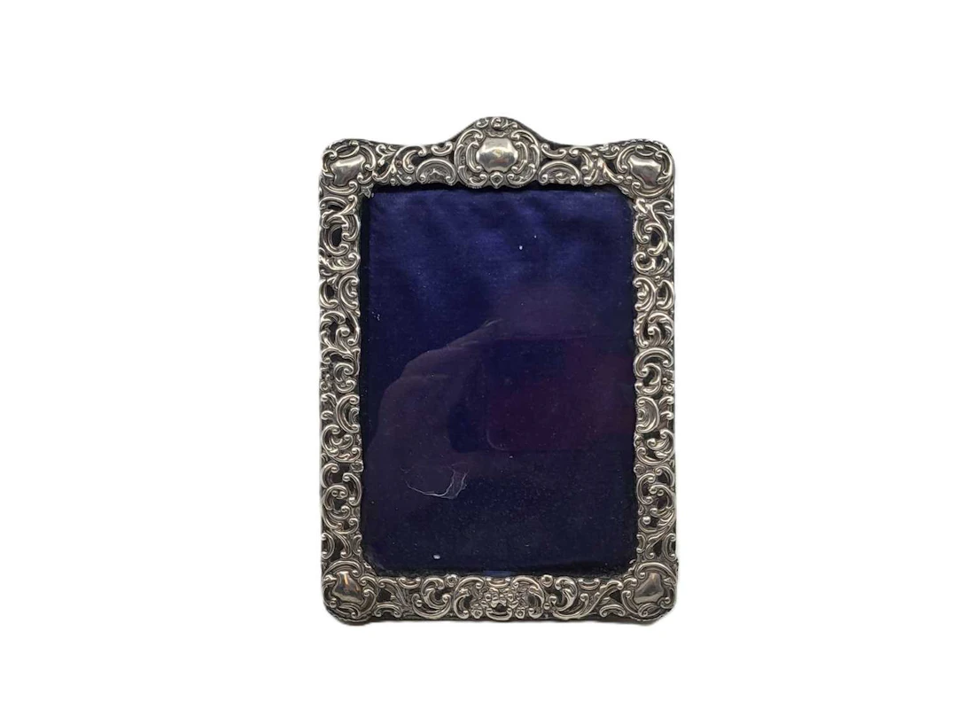 A SILVER EMBOSSED PHOTO FRAME