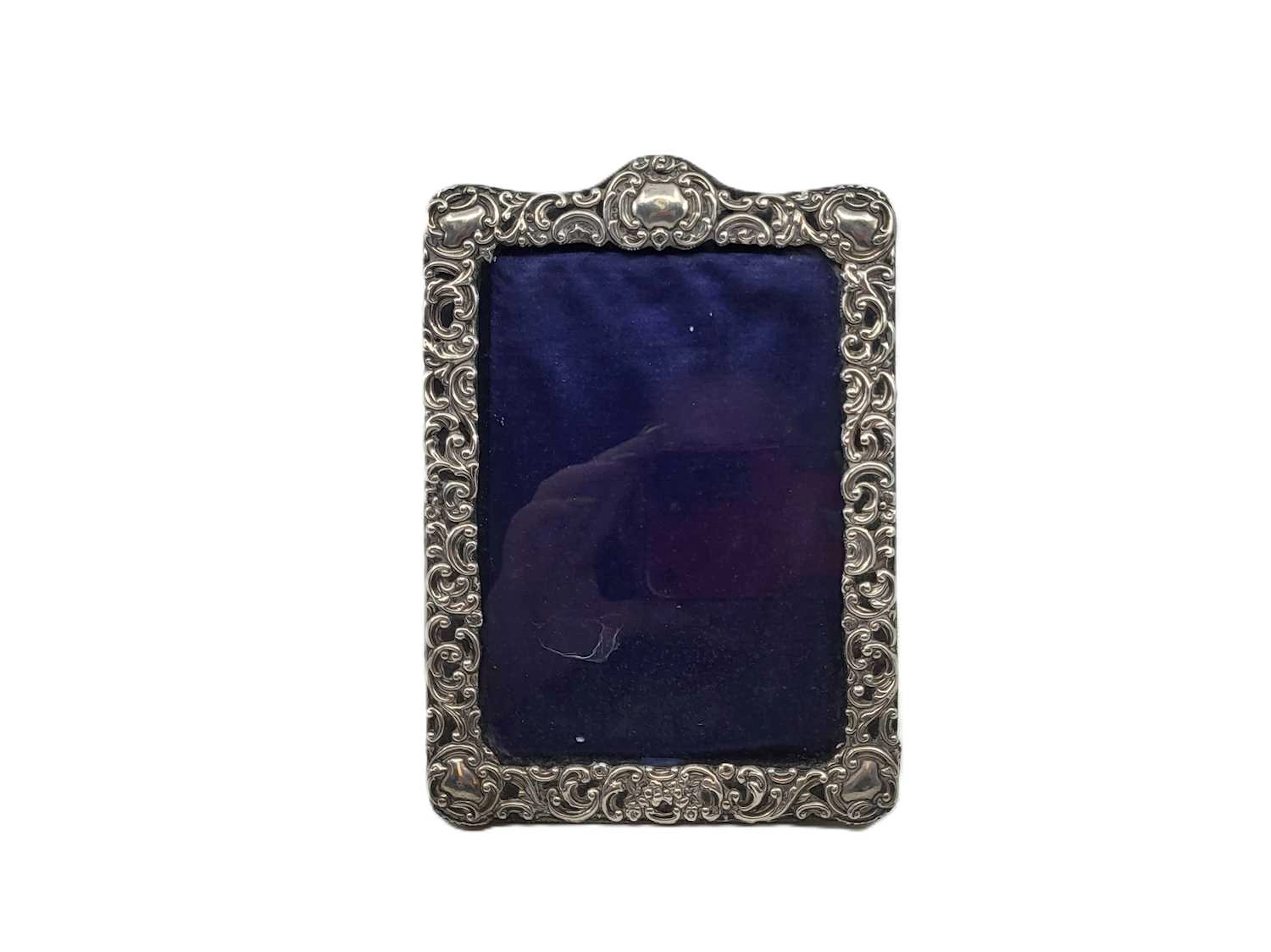A SILVER EMBOSSED PHOTO FRAME