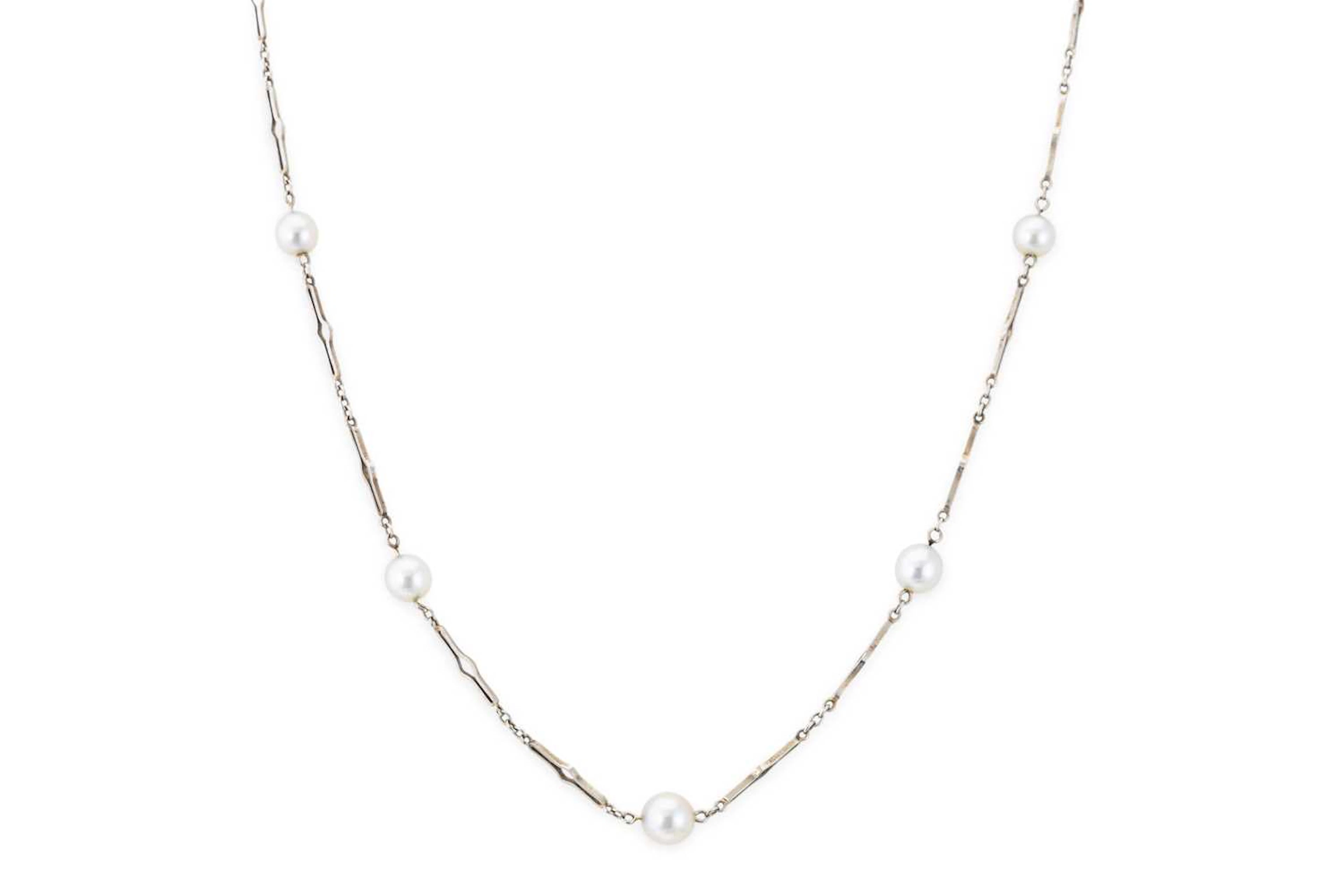 AN ART DECO 18CT WHITE GOLD STATION NECKLACE