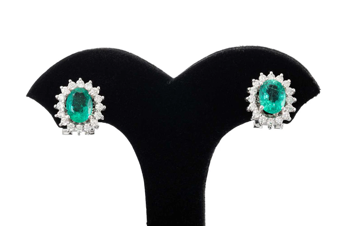 A PAIR OF EMERALD AND DIAMOND CLUSTER EARRINGS