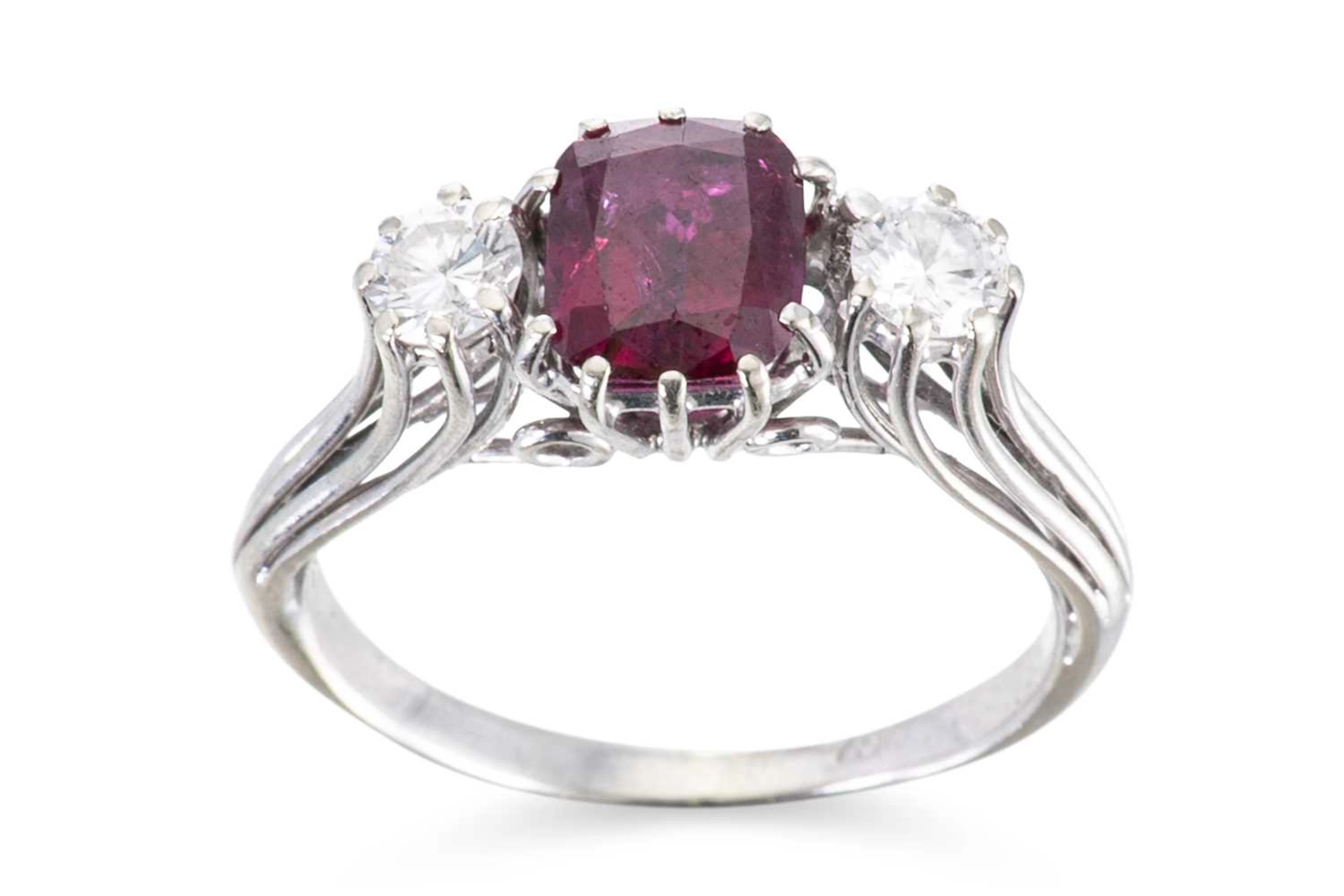 A GARNET AND DIAMOND THREE STONE RING