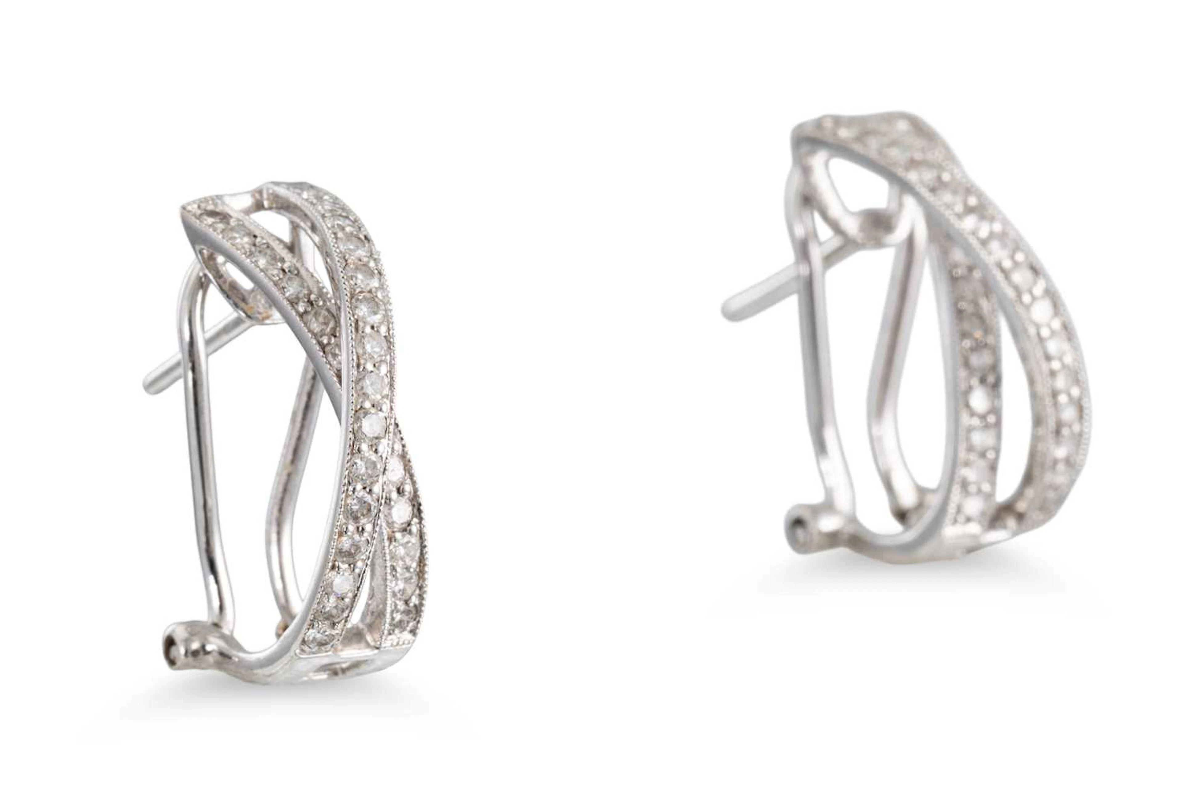 A PAIR OF DIAMOND SET CROSS OVER EARRINGS