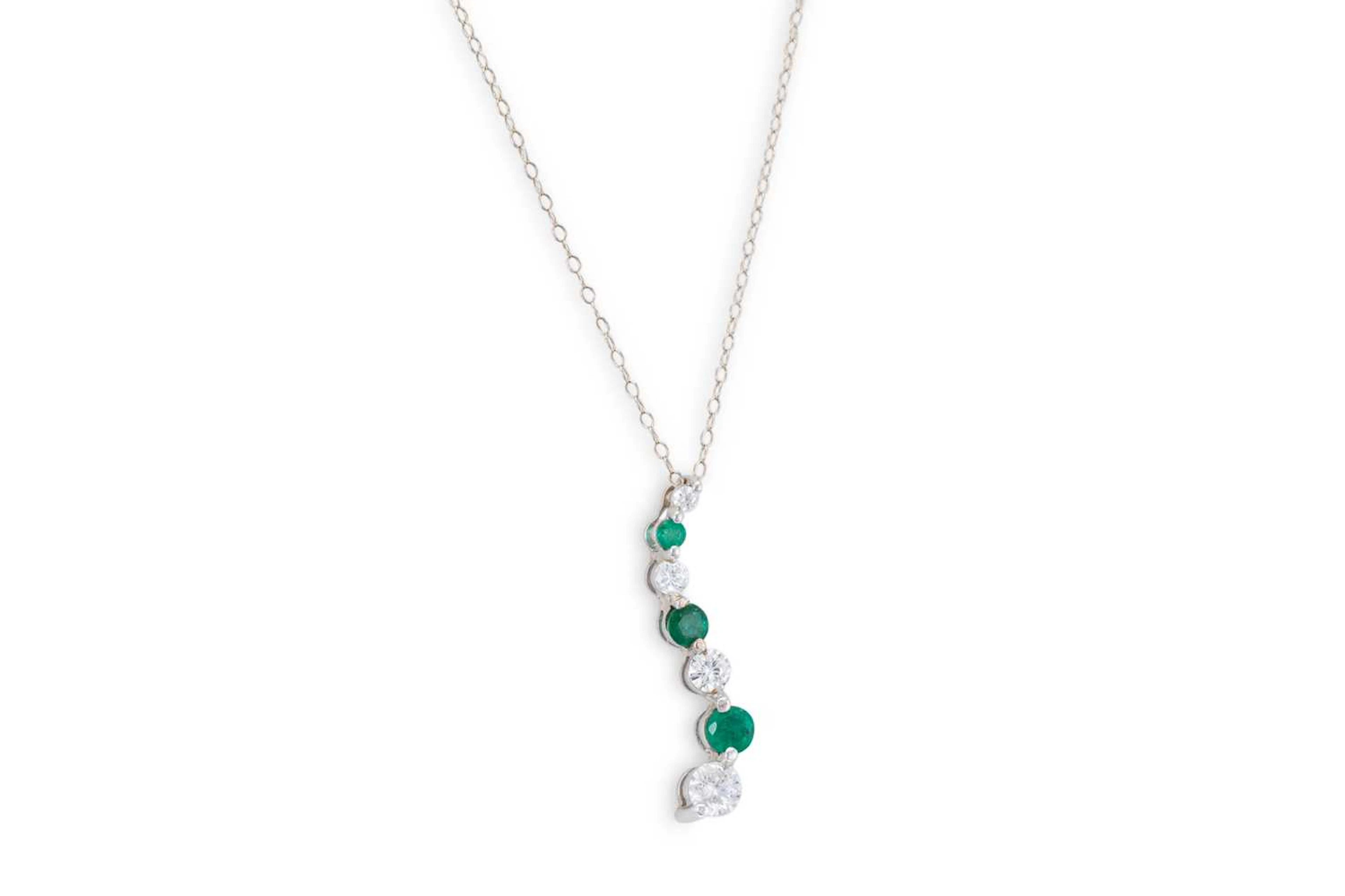 AN EMERALD AND DIAMOND PENDANT