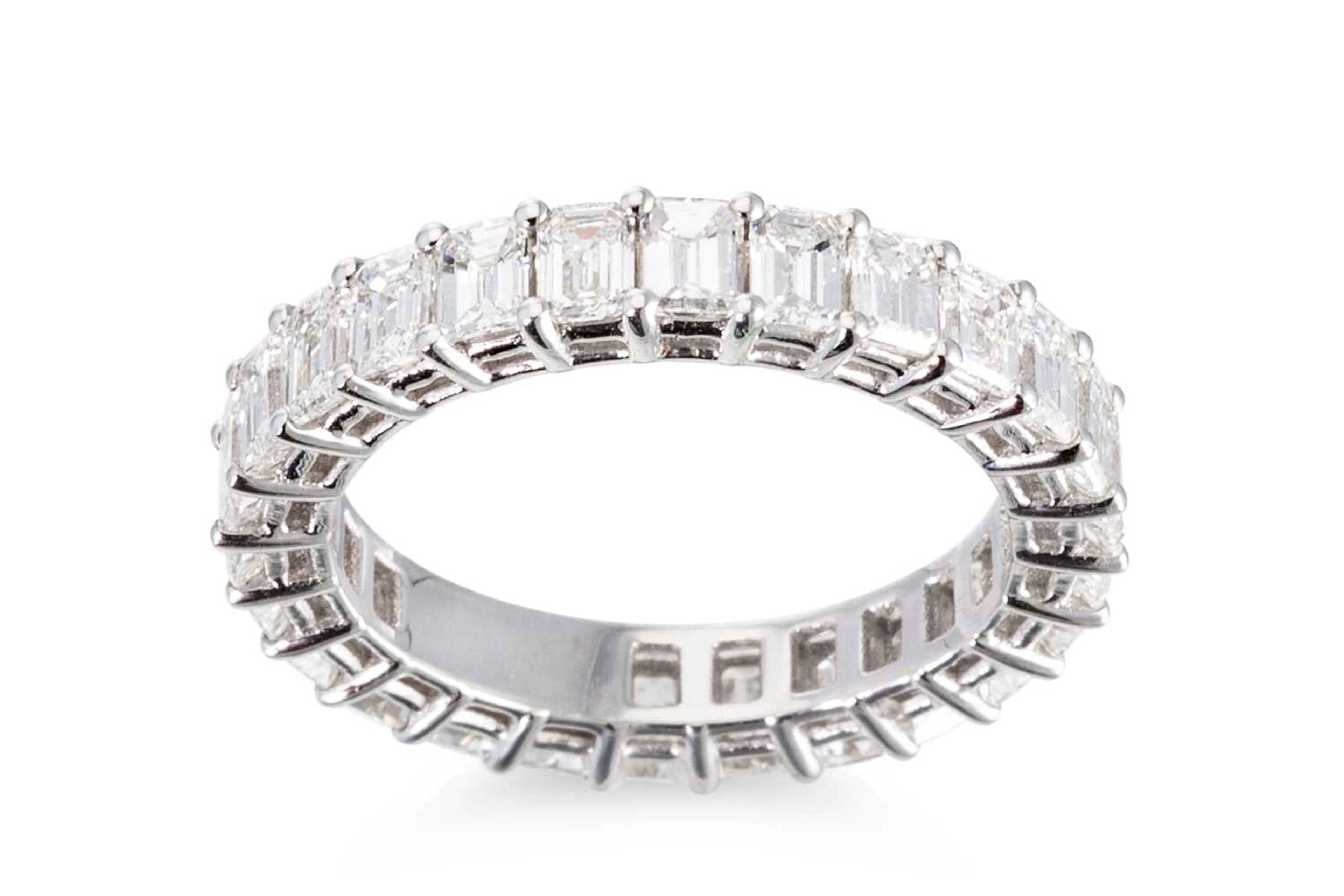 AN EMERALD CUT DIAMOND FULL BANDED ETERNITY RING
