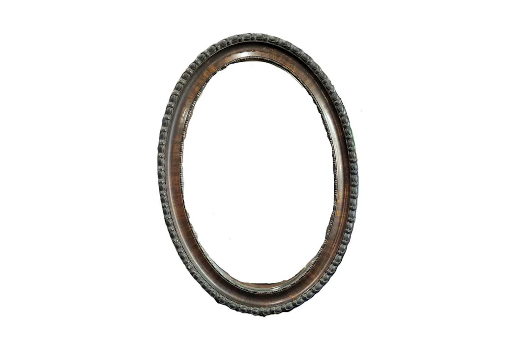 AN EDWARDIAN OVAL BEVEL GLASS WALL HALL MIRROR