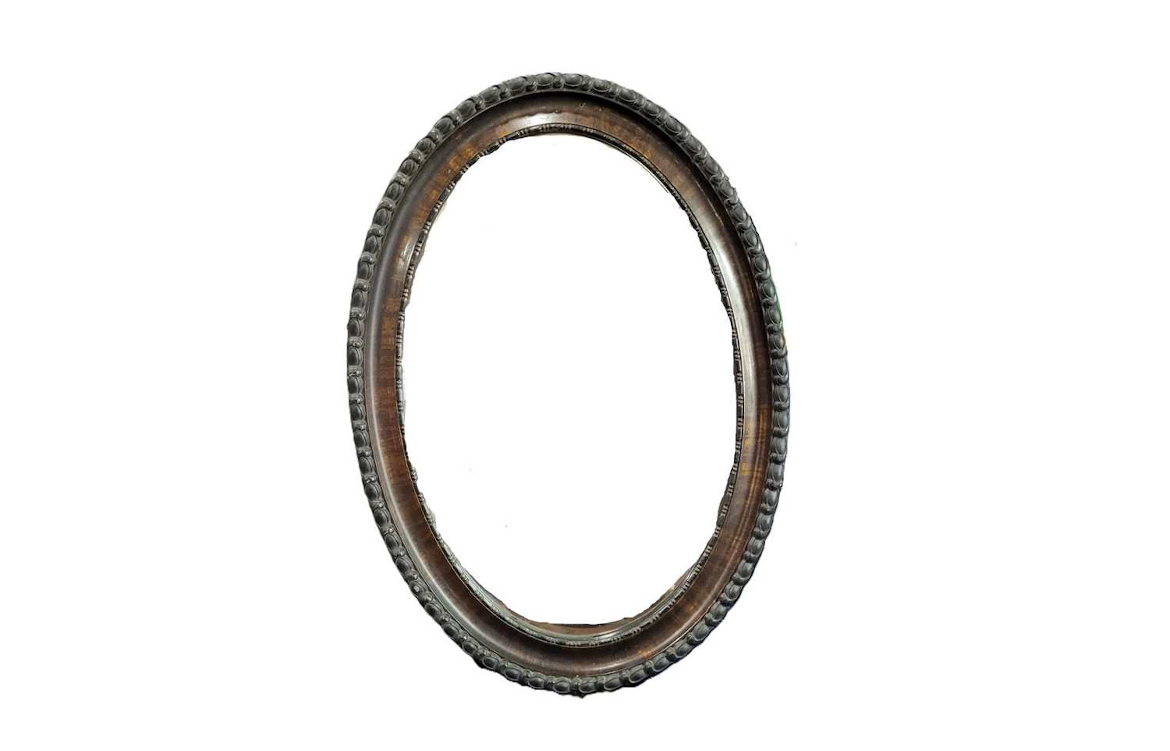 AN EDWARDIAN OVAL BEVEL GLASS WALL HALL MIRROR