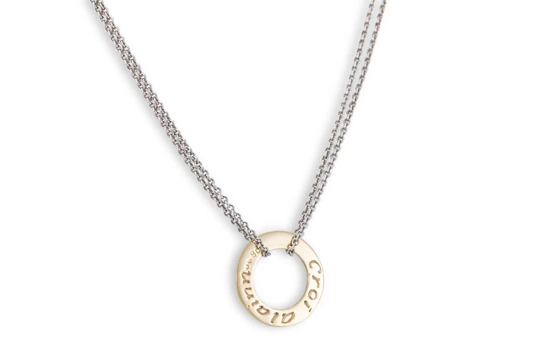 A PENDANT BY 'SANIBA' with a 9ct gold circular disk