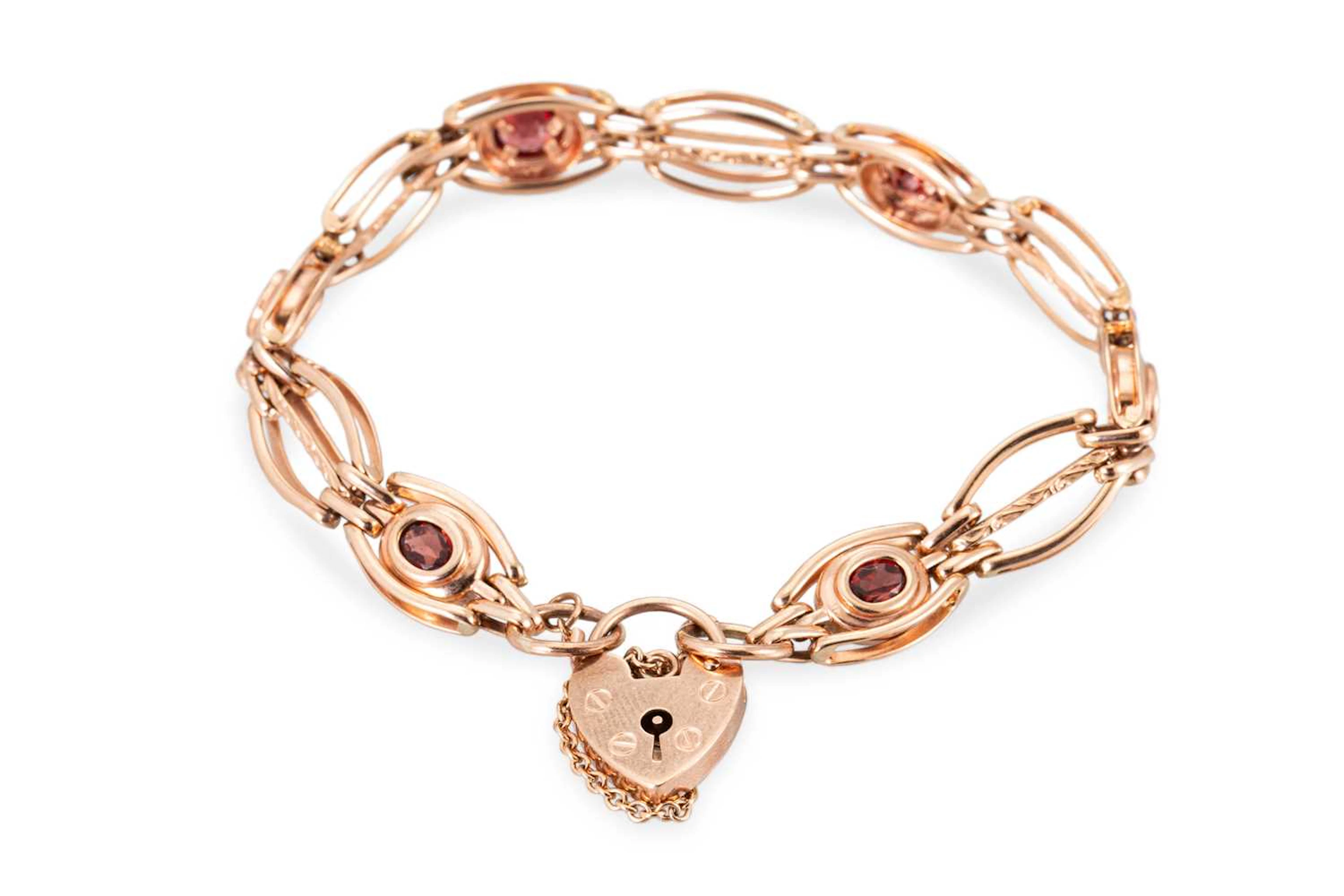 A 9CT ROSE GOLD GARNET SET BRACELET