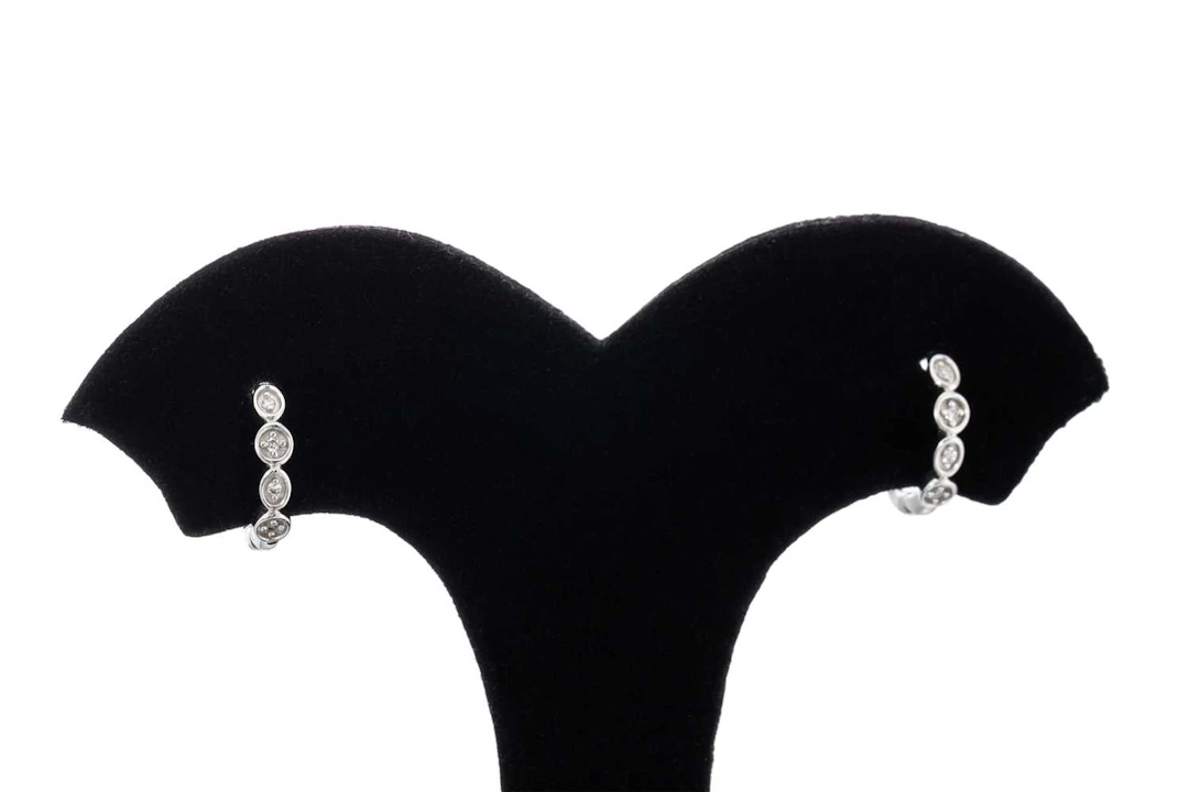 A PAIR OF HUGGIE DIAMOND EARRINGS