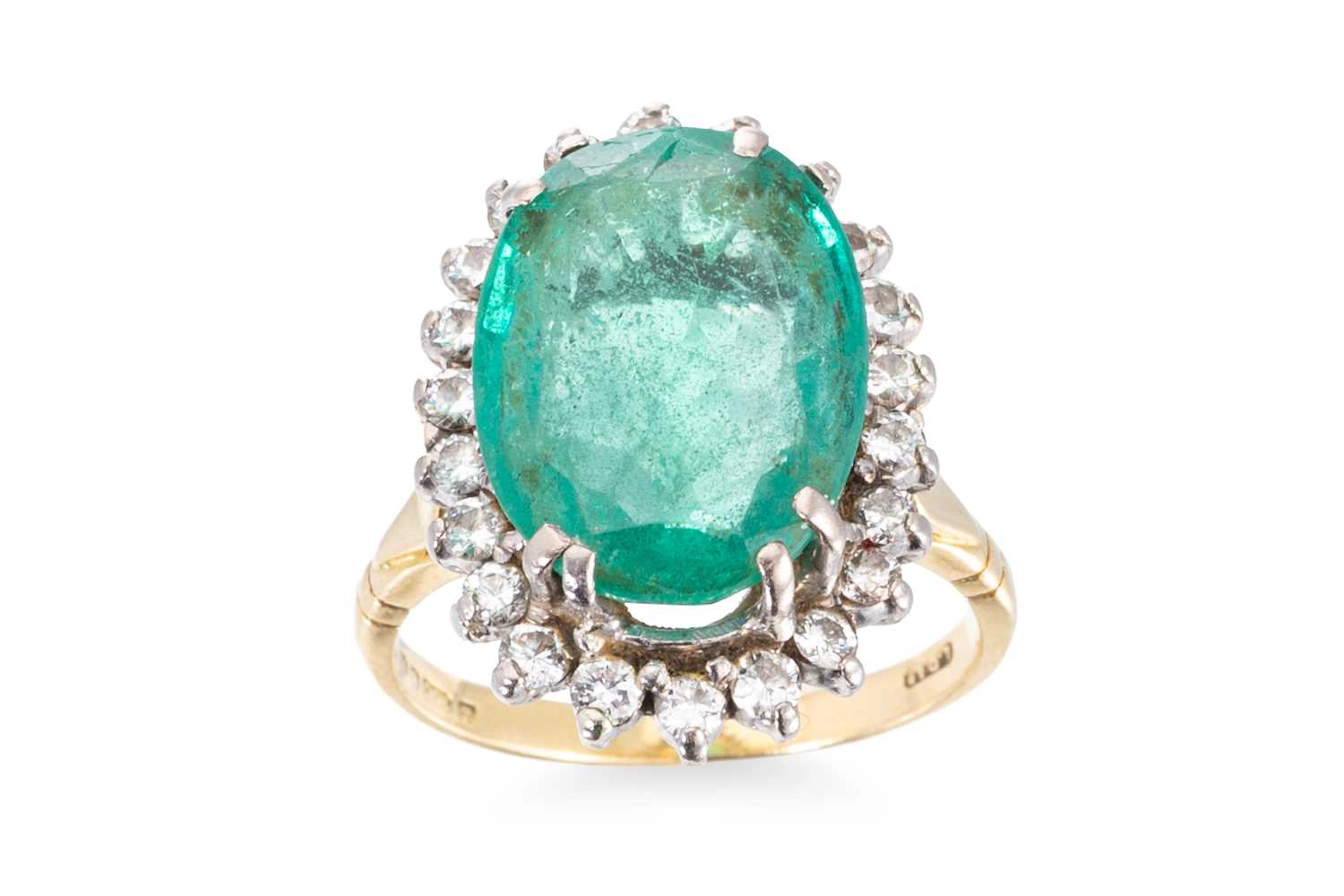 AN EMERALD AND DIAMOND CLUSTER RING