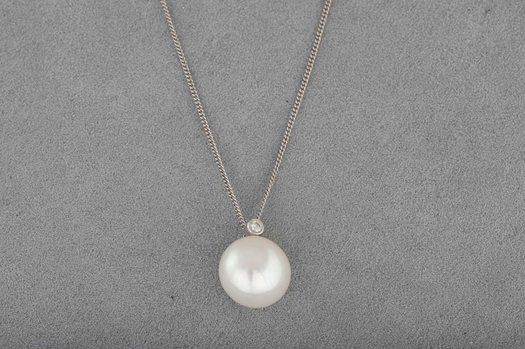 A CULTURED PEARL AND DIAMOND PENDANT
