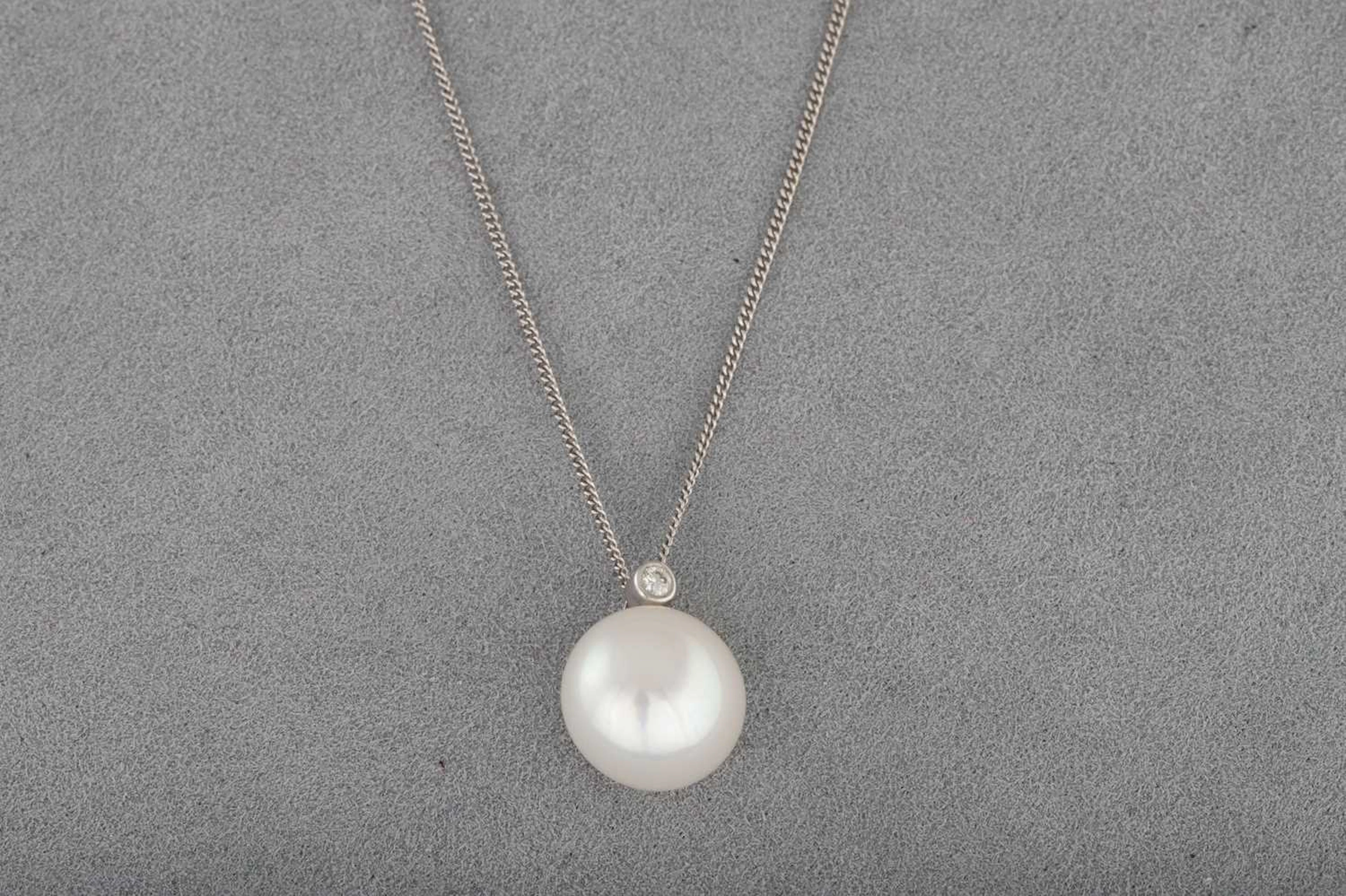 A CULTURED PEARL AND DIAMOND PENDANT