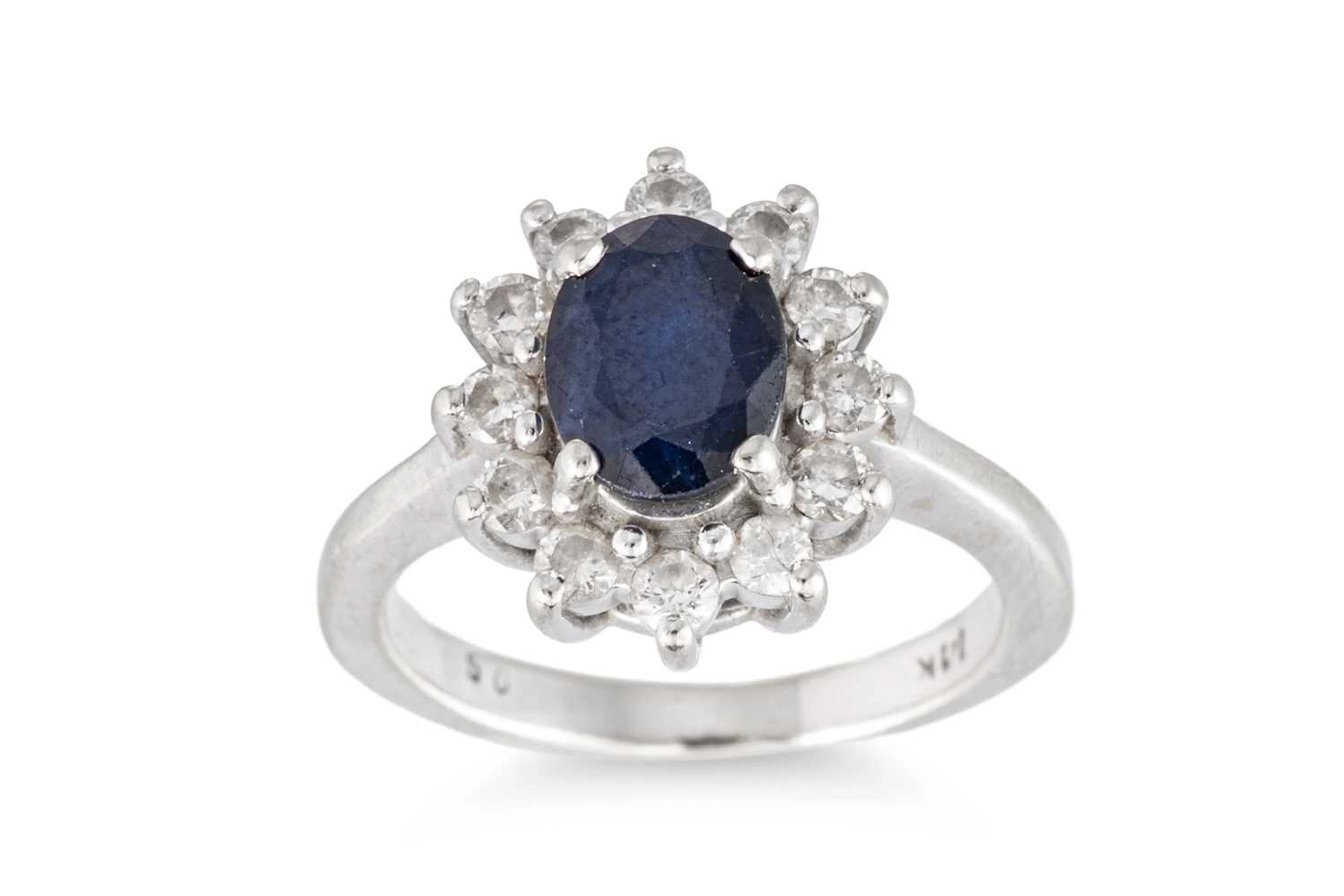 A SAPPHIRE AND DIAMOND CLUSTER RING
