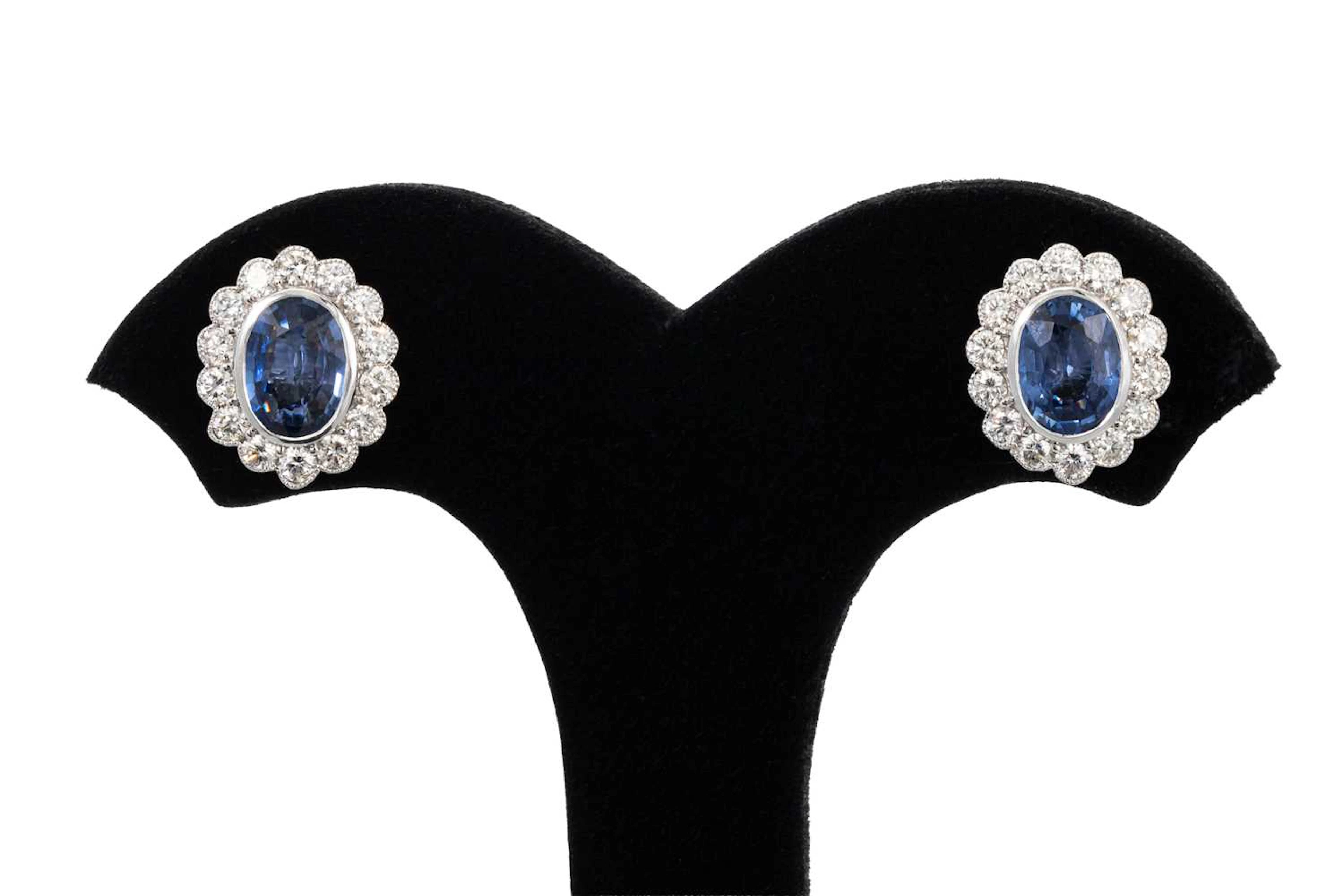 A PAIR OF SAPPHIRE AND DIAMOND CLUSTER EARRINGS