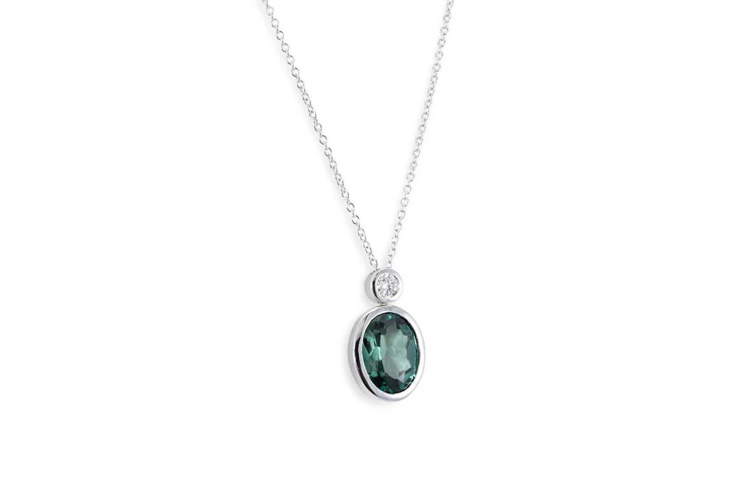 A GREEN TOURMALINE AND DIAMOND SET PENDANT