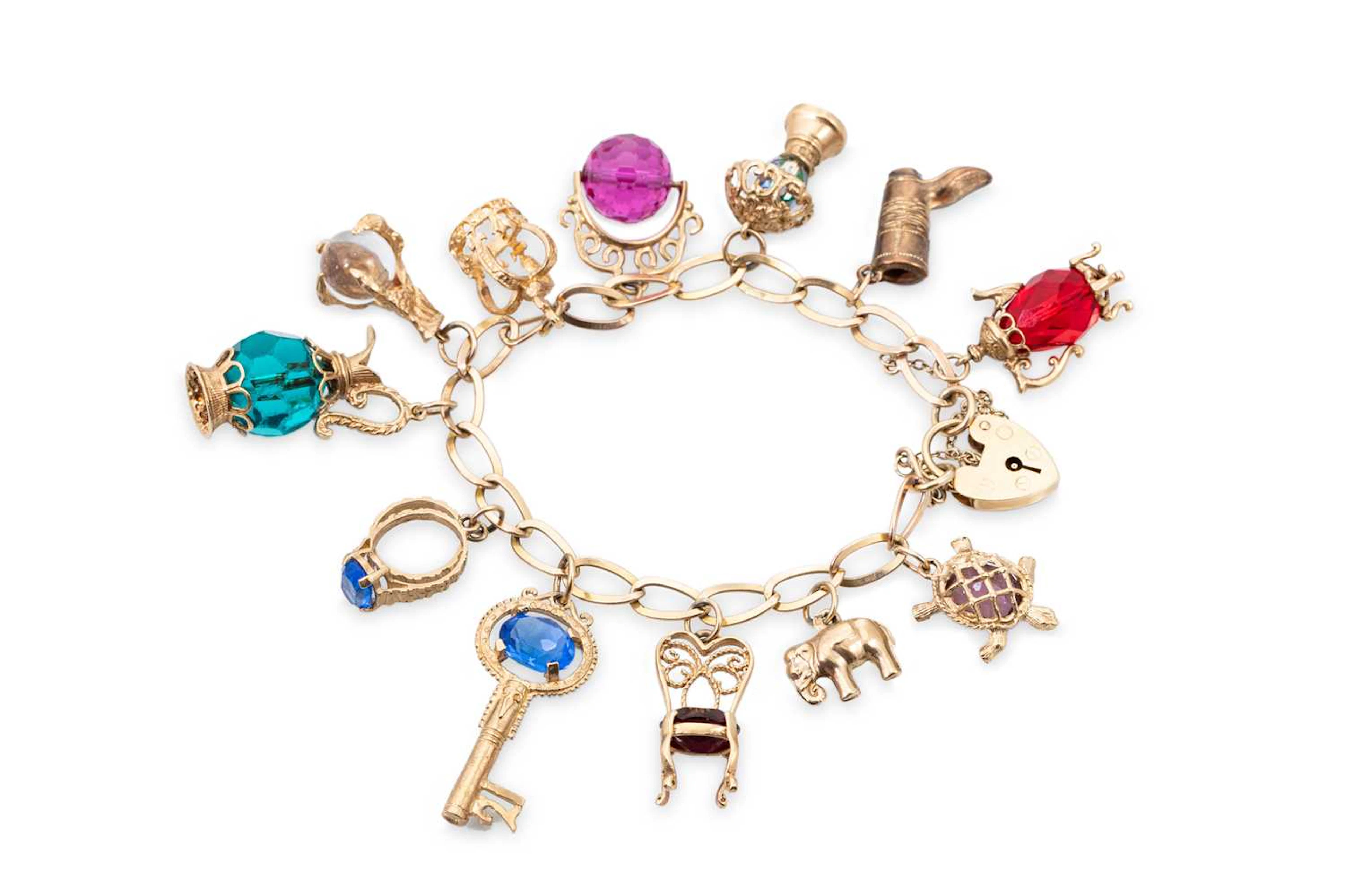 A 9CT GOLD CHARM BRACELET