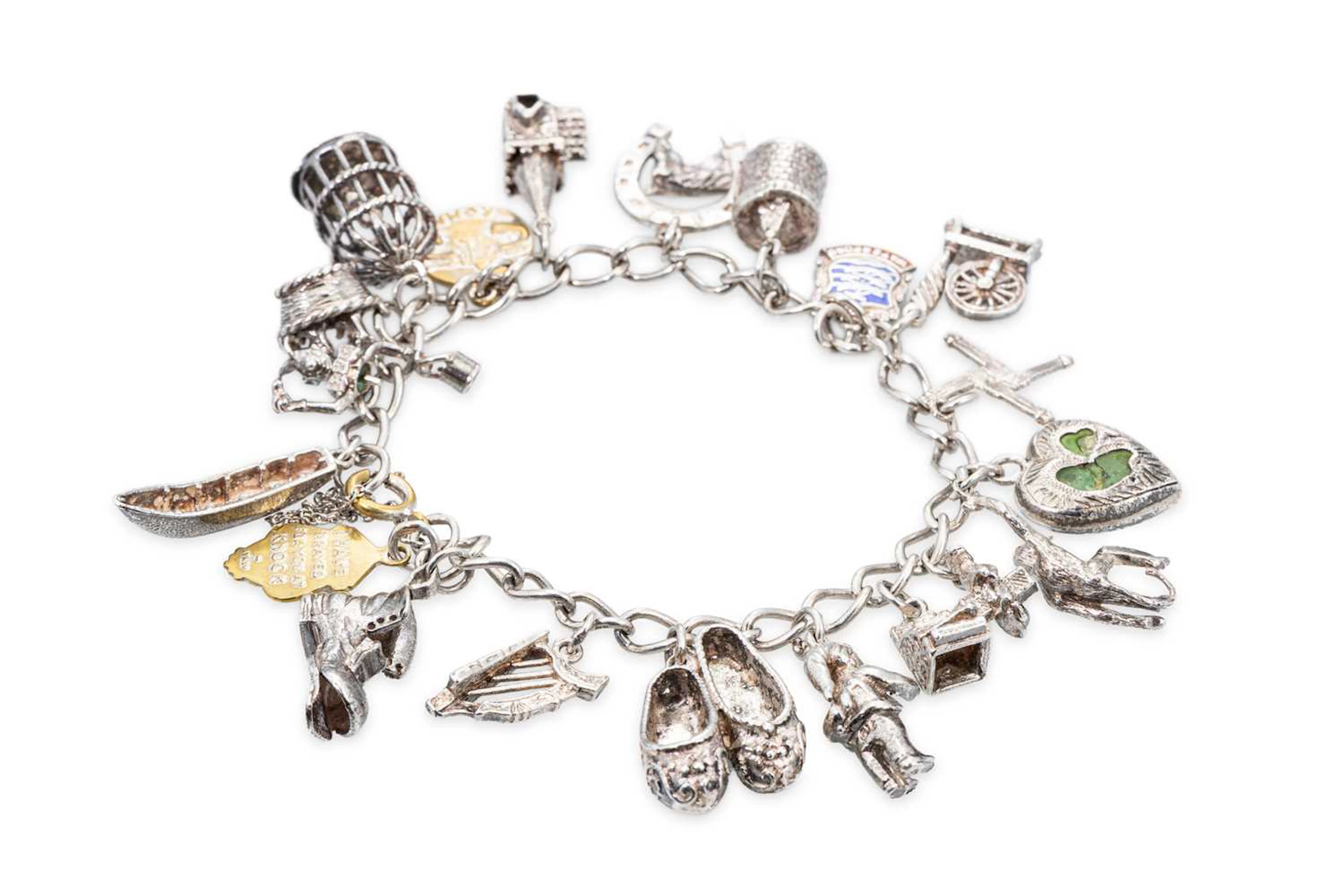 A STERLING SILVER CHARM BRACELET