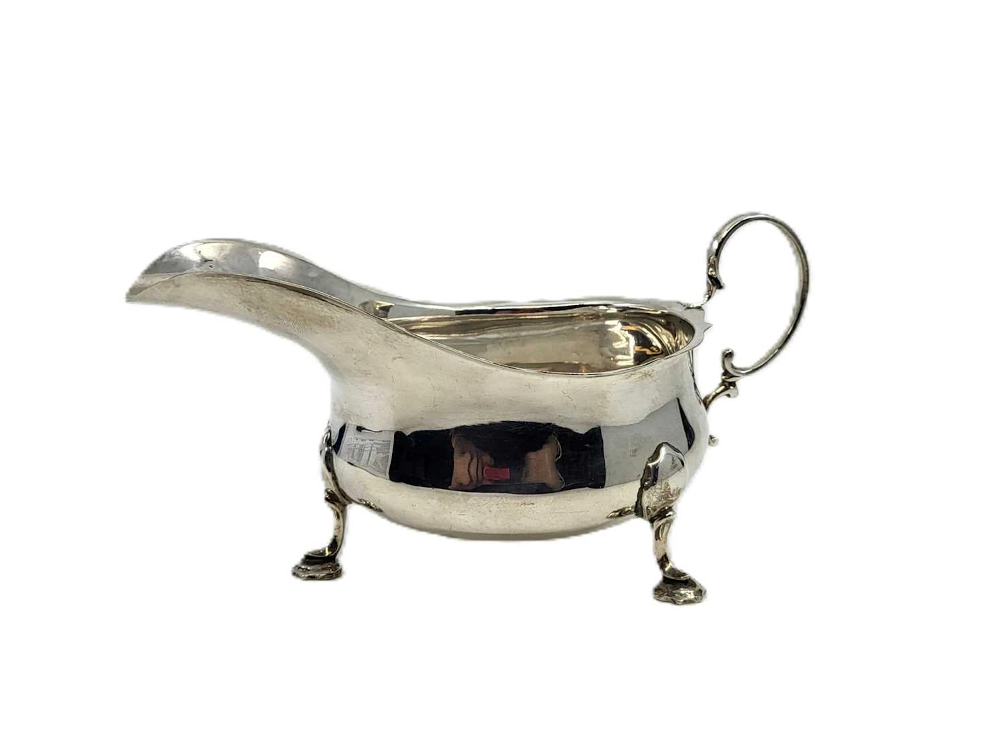 A MID-20TH-CENTURY SILVER (.925) MAPPIN & WEBB HELMET SHAPED SAUCE BOAT