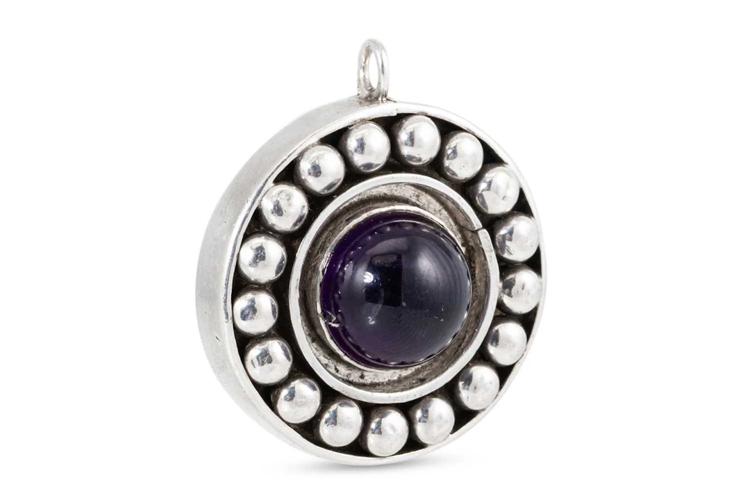 A MARIKA MURNAGHAN AMETHYST SET CIRCULAR PENDANT