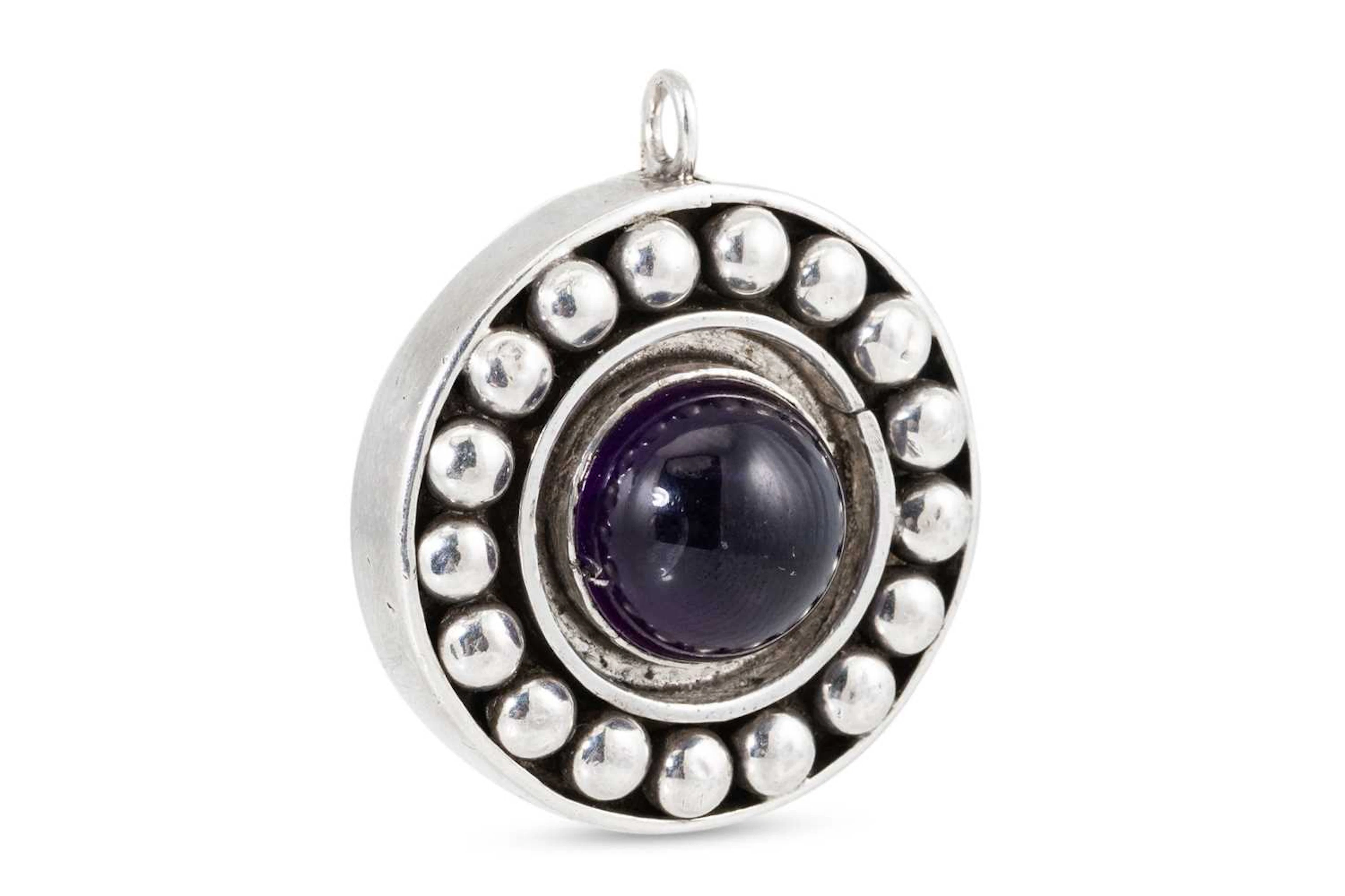 A MARIKA MURNAGHAN AMETHYST SET CIRCULAR PENDANT