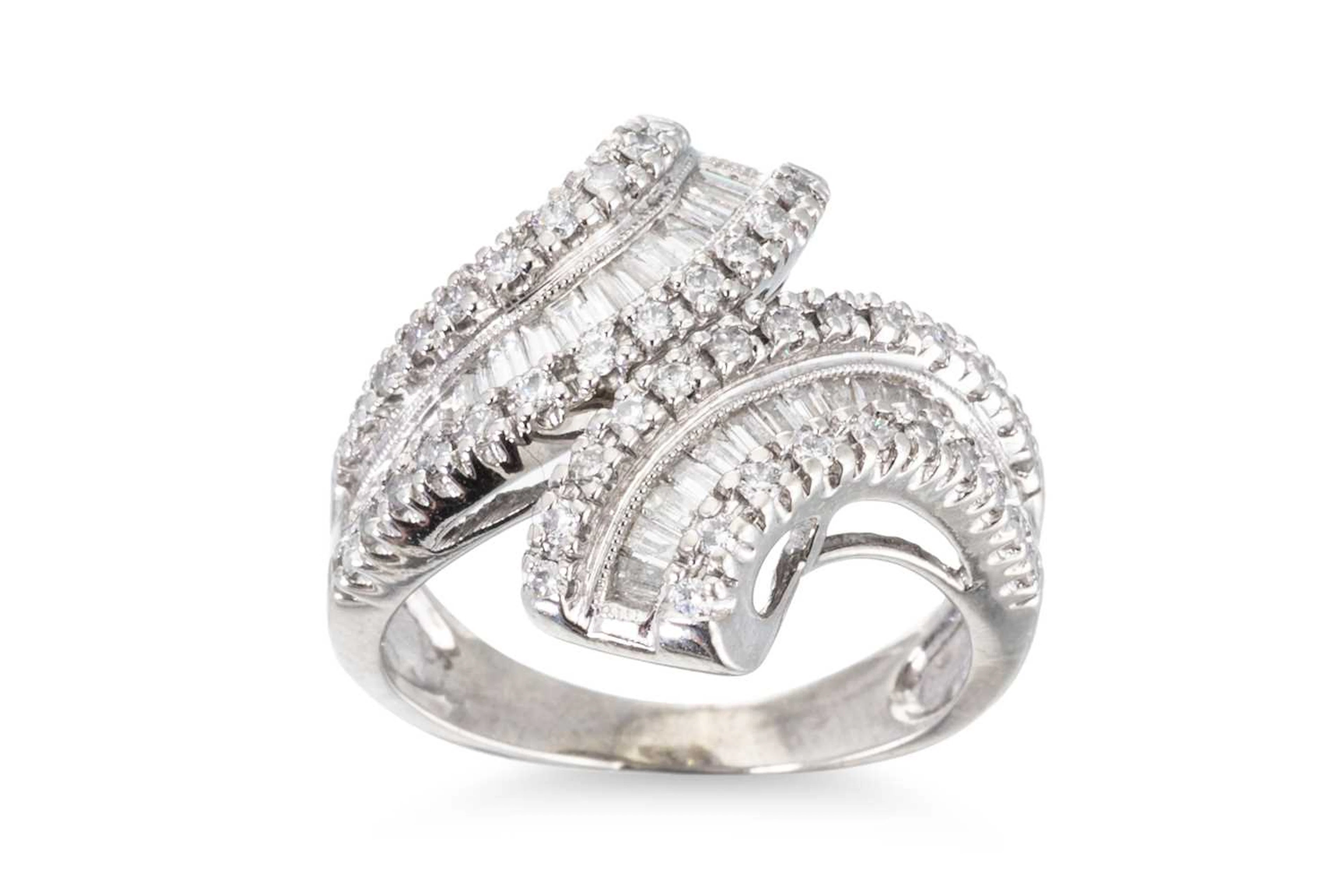 A 14CT WHITE GOLD DIAMOND SET CROSS OVER DRESS RING