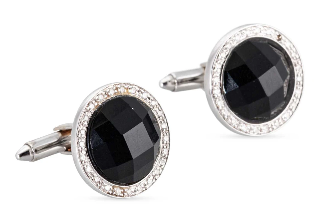 A PAIR OF ONYX AND DIAMOND SET CUFFLINKS