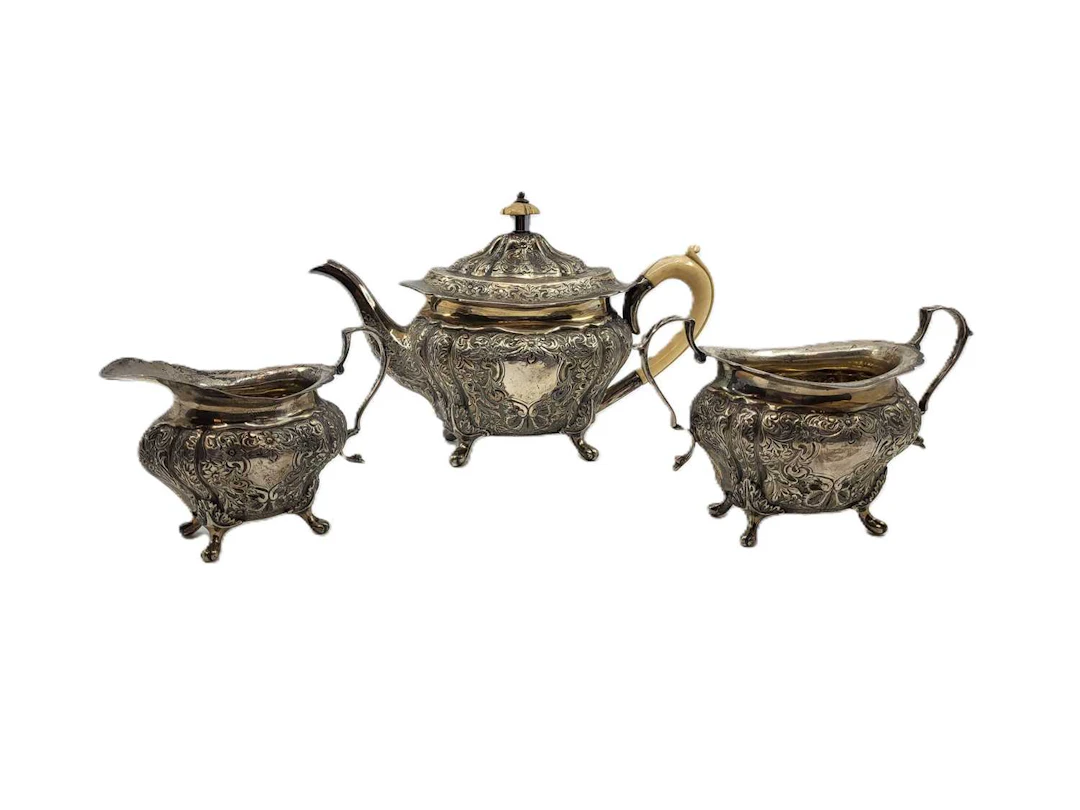 A THREE PIECE ANTIQUE EDWARDIAN STERLING SILVER EMBOSSED BACHELOR'S TEA SET