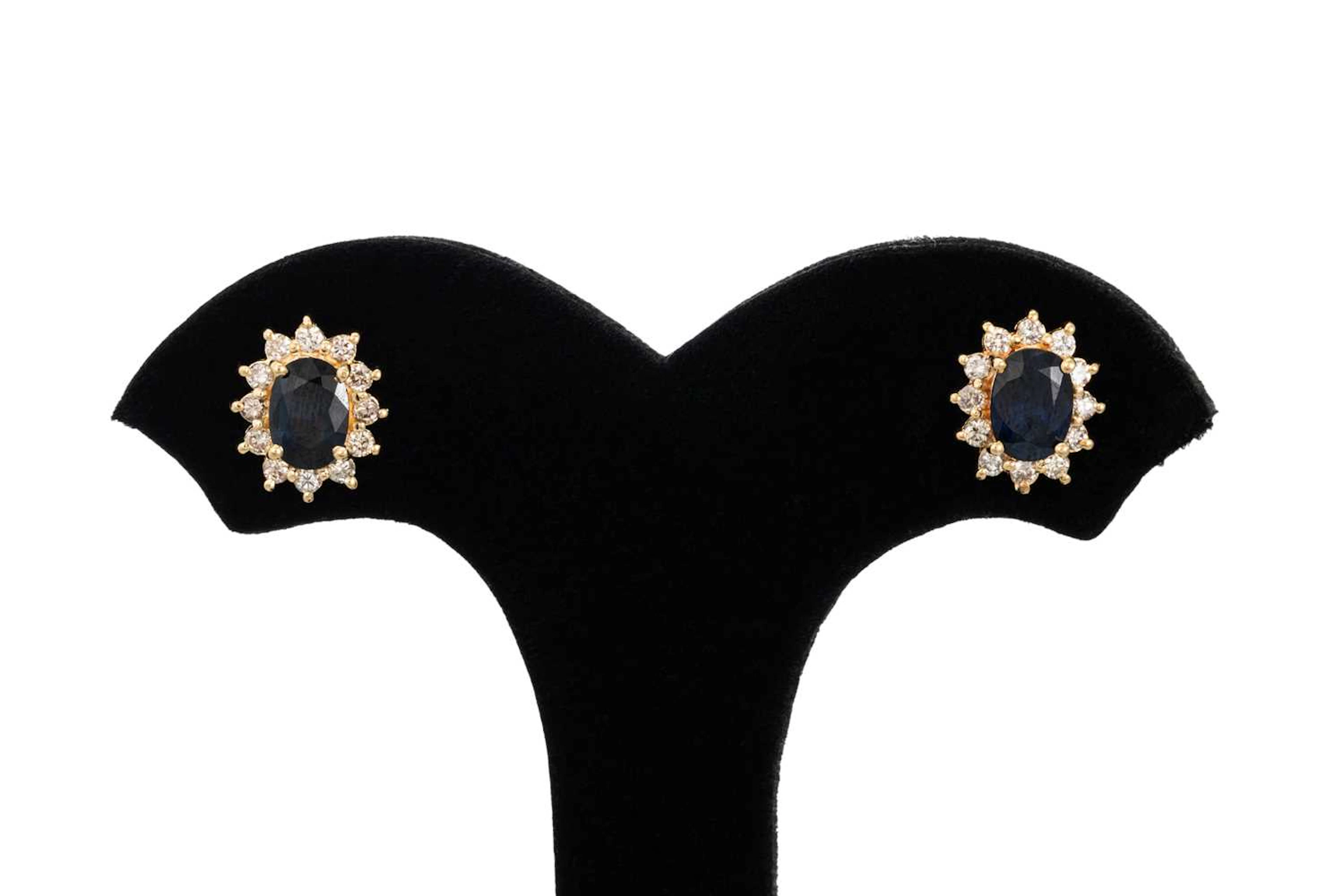 A PAIR OF DIAMOND AND SAPPHIRE CLUSTER EARRINGS
