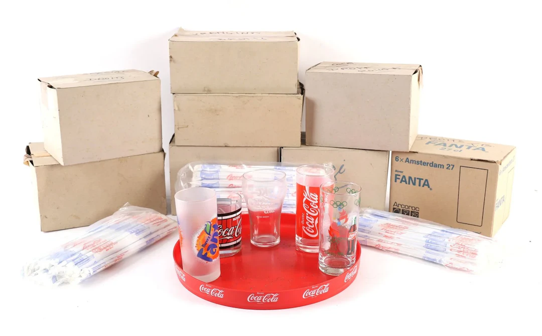 SET OF 46 COCA-COLA, ORANGINA, FANTA, AND OTHER GLASSES. - Lot 185