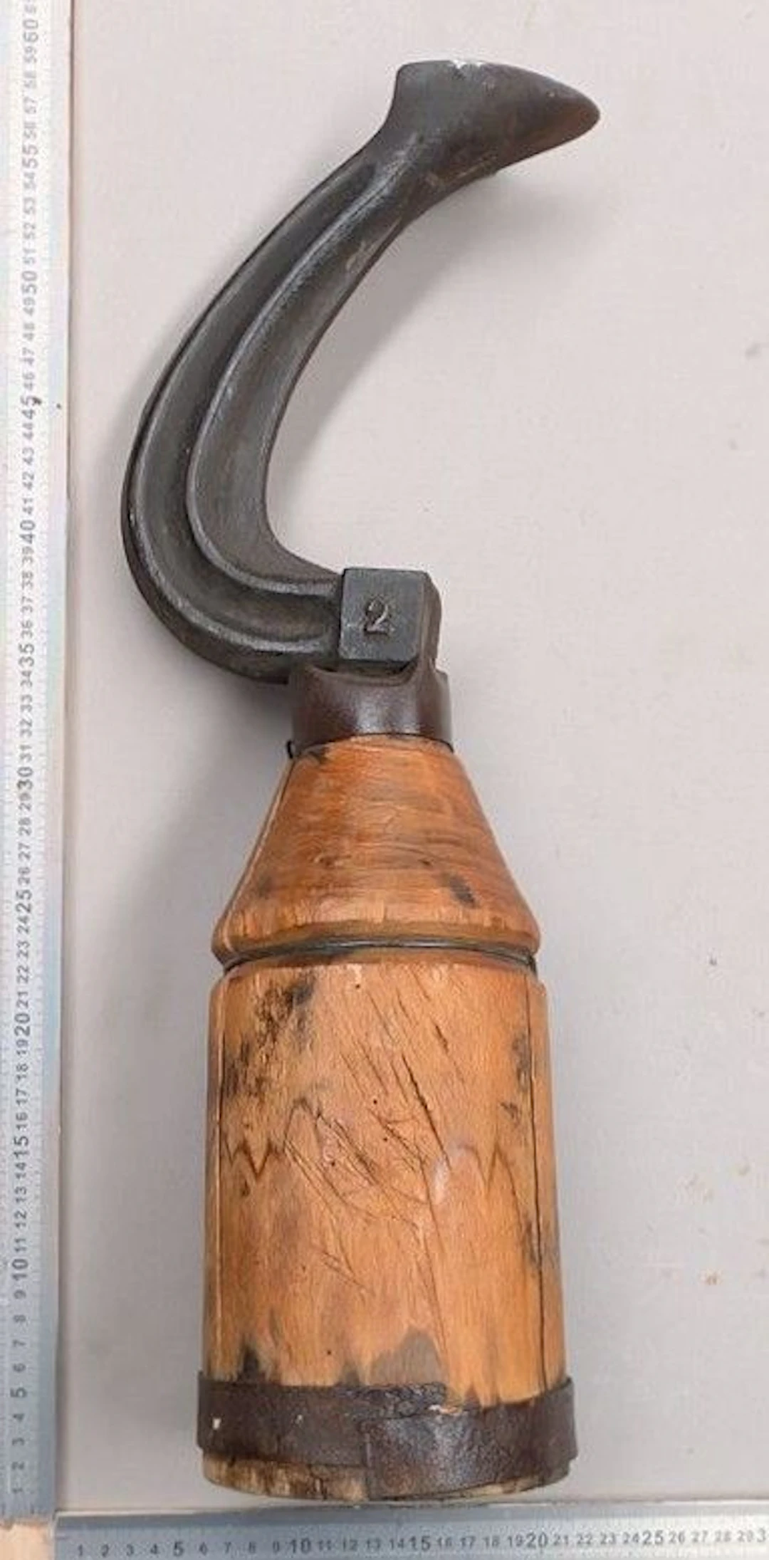 Antique wrought-iron shoemaker's anvil on a wooden base—see photos