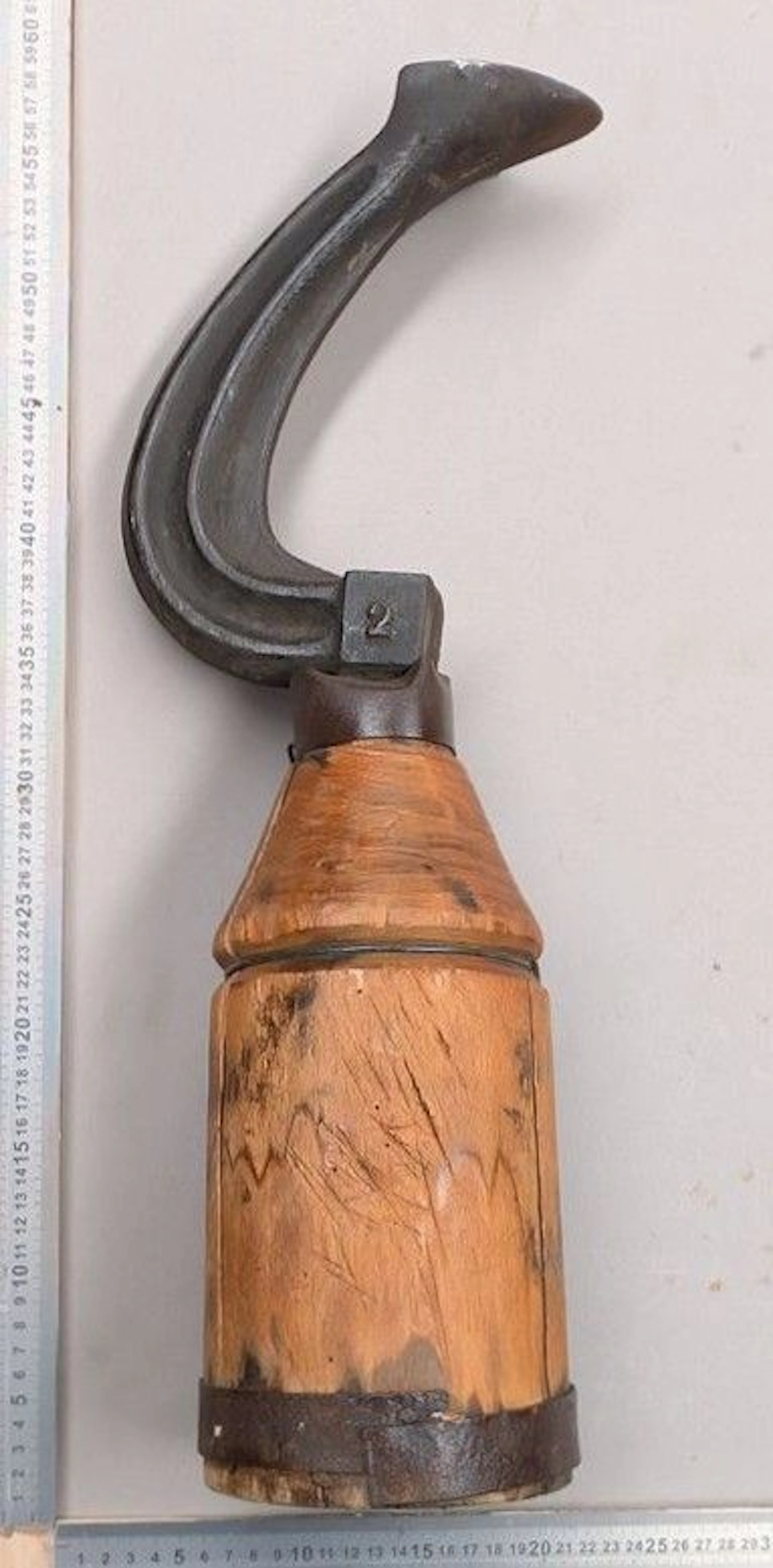 Antique wrought-iron shoemaker's anvil on a wooden base—see photos