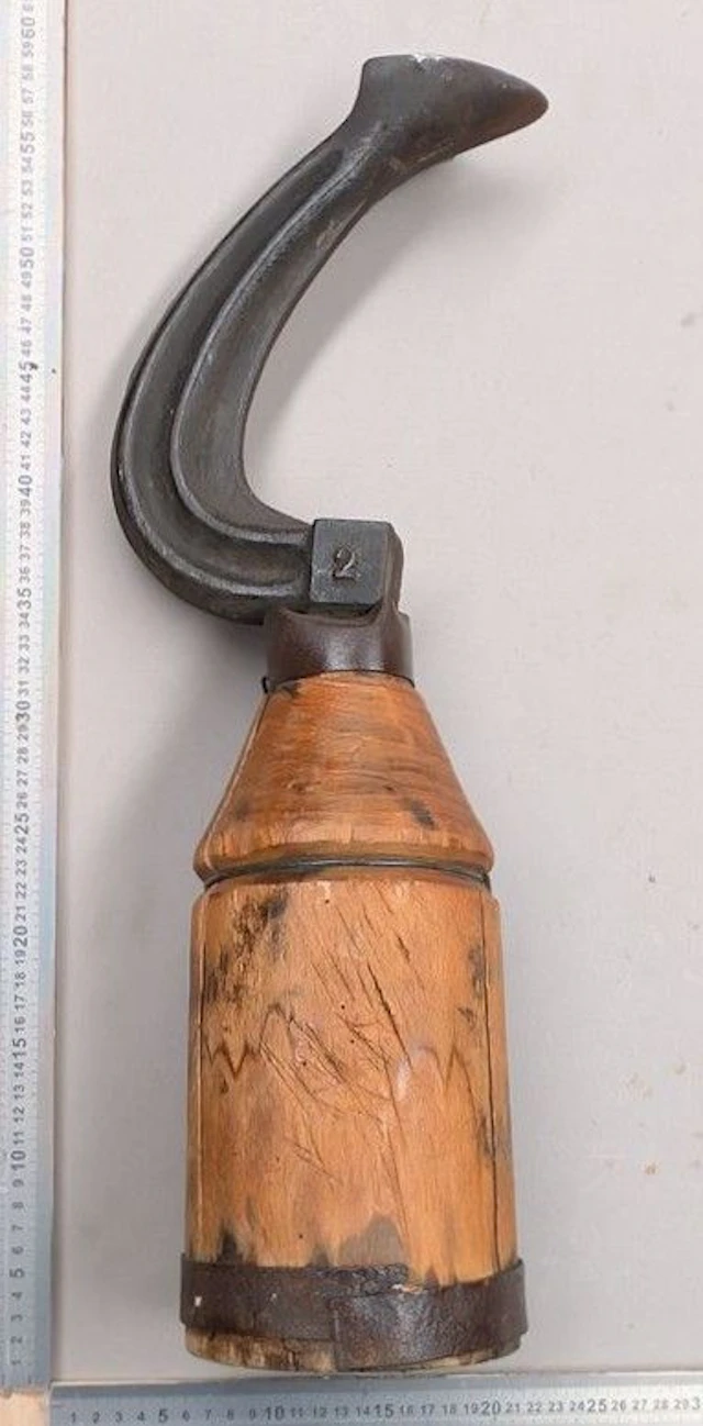 Antique wrought-iron shoemaker's anvil on a wooden base—see photos