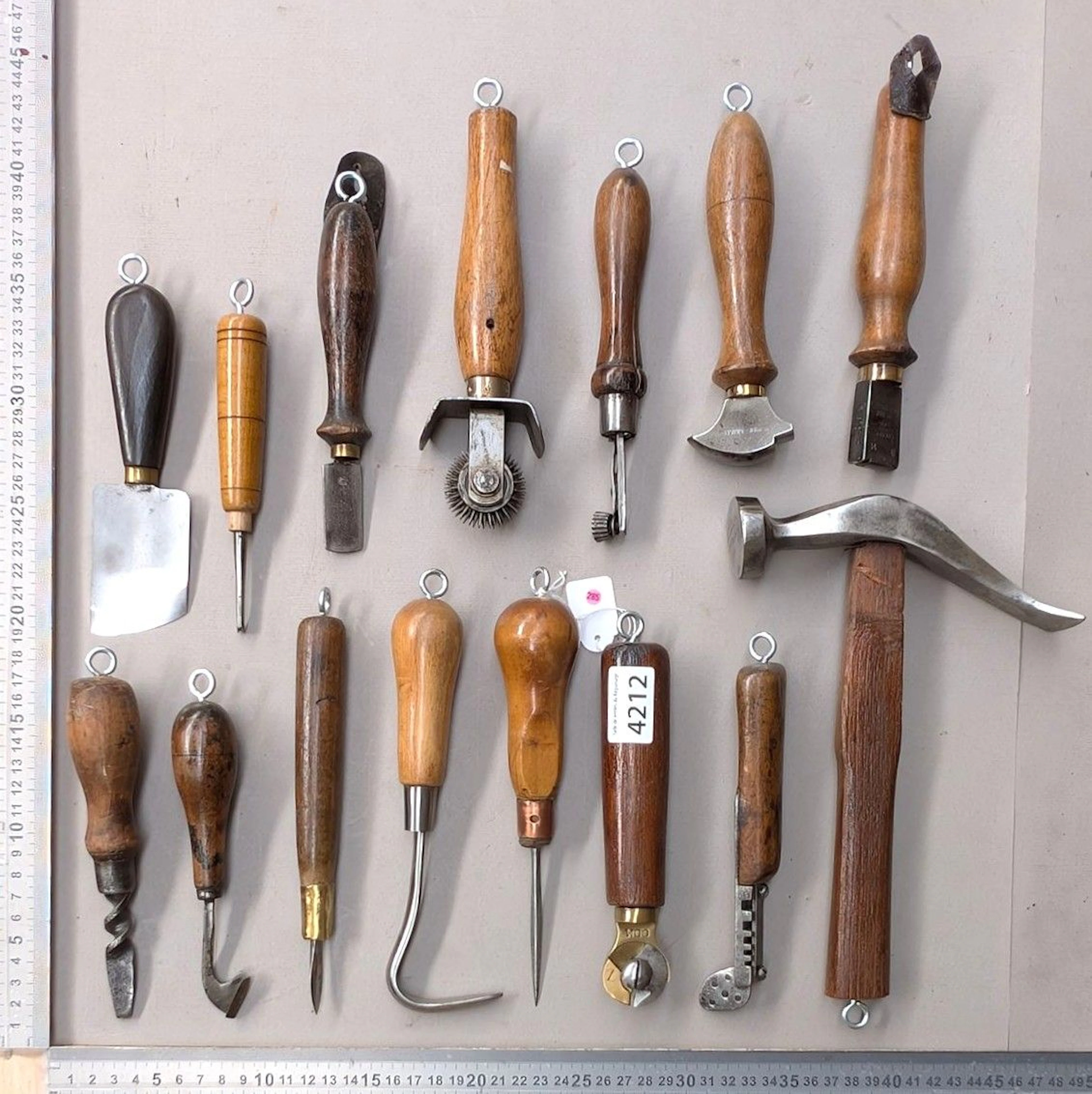15 shoemaker's and saddler's tools on an oak base—see photos for dimensions