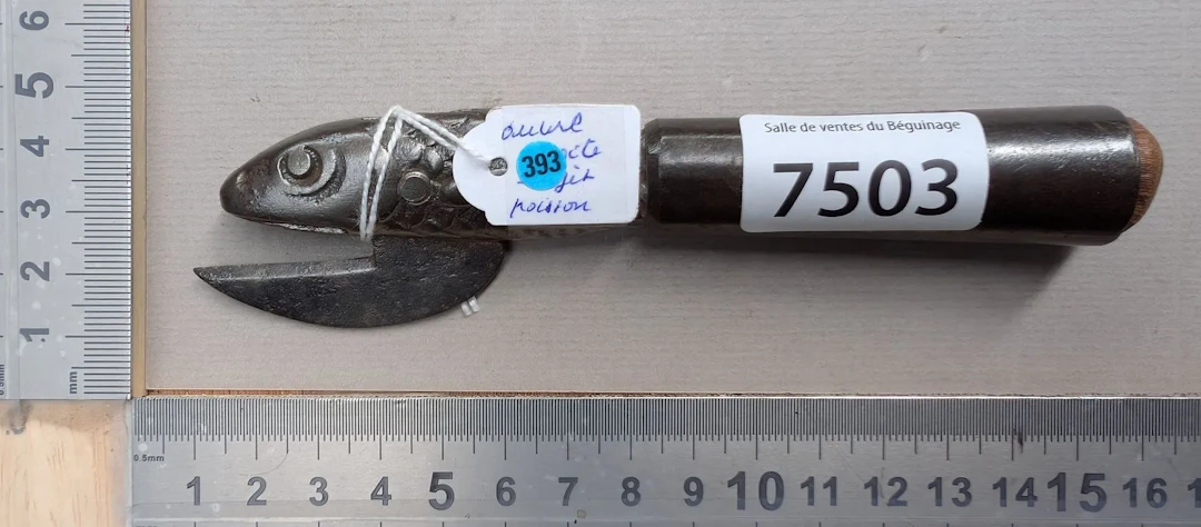 1 antique cast-iron can opener shaped like a fish—see photos for dimensions