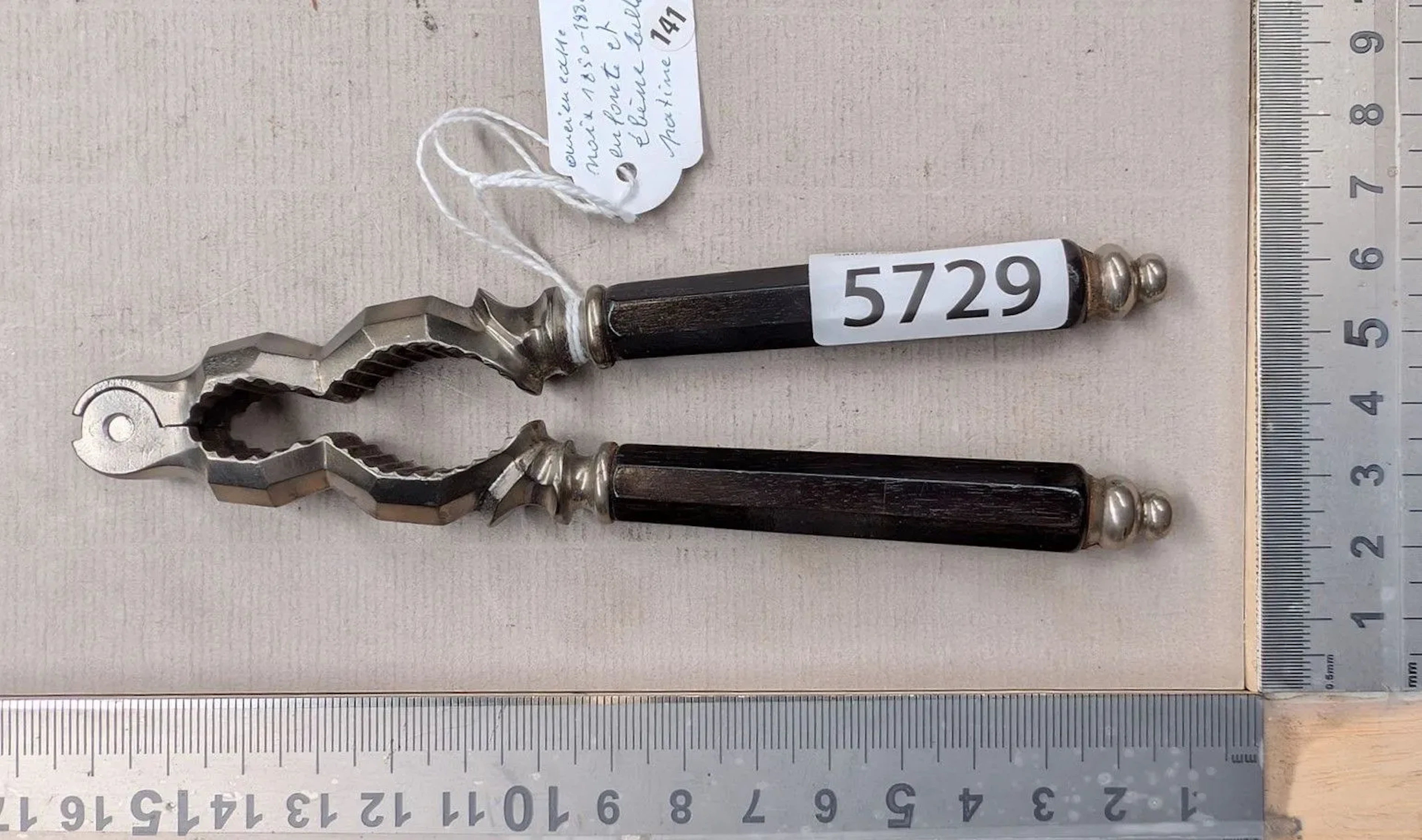 An antique nutcracker, 1850–1900, made of cast iron and ebony, with