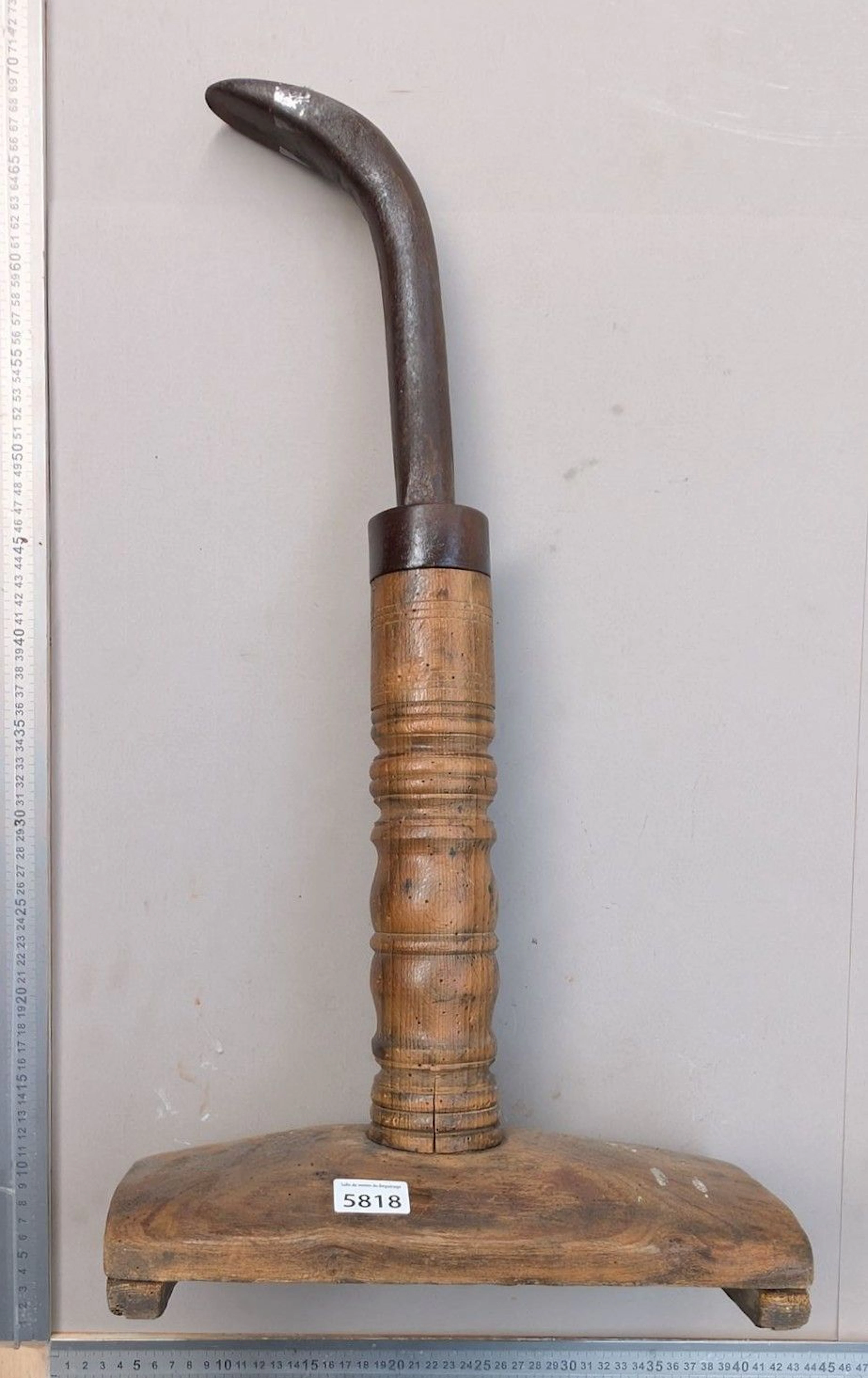 Antique wrought-iron shoemaker's anvil on a wooden base—see photos