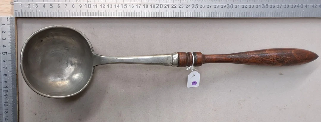 Beautiful pewter ladle with a turned wooden handle—see photos for
