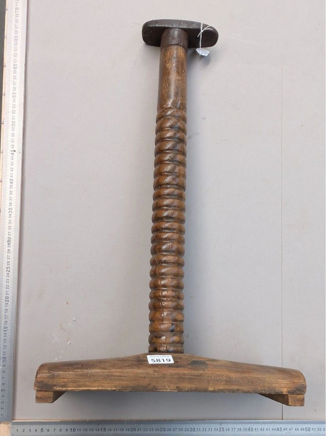 Antique wrought-iron shoemaker's anvil on a wooden base—see photos