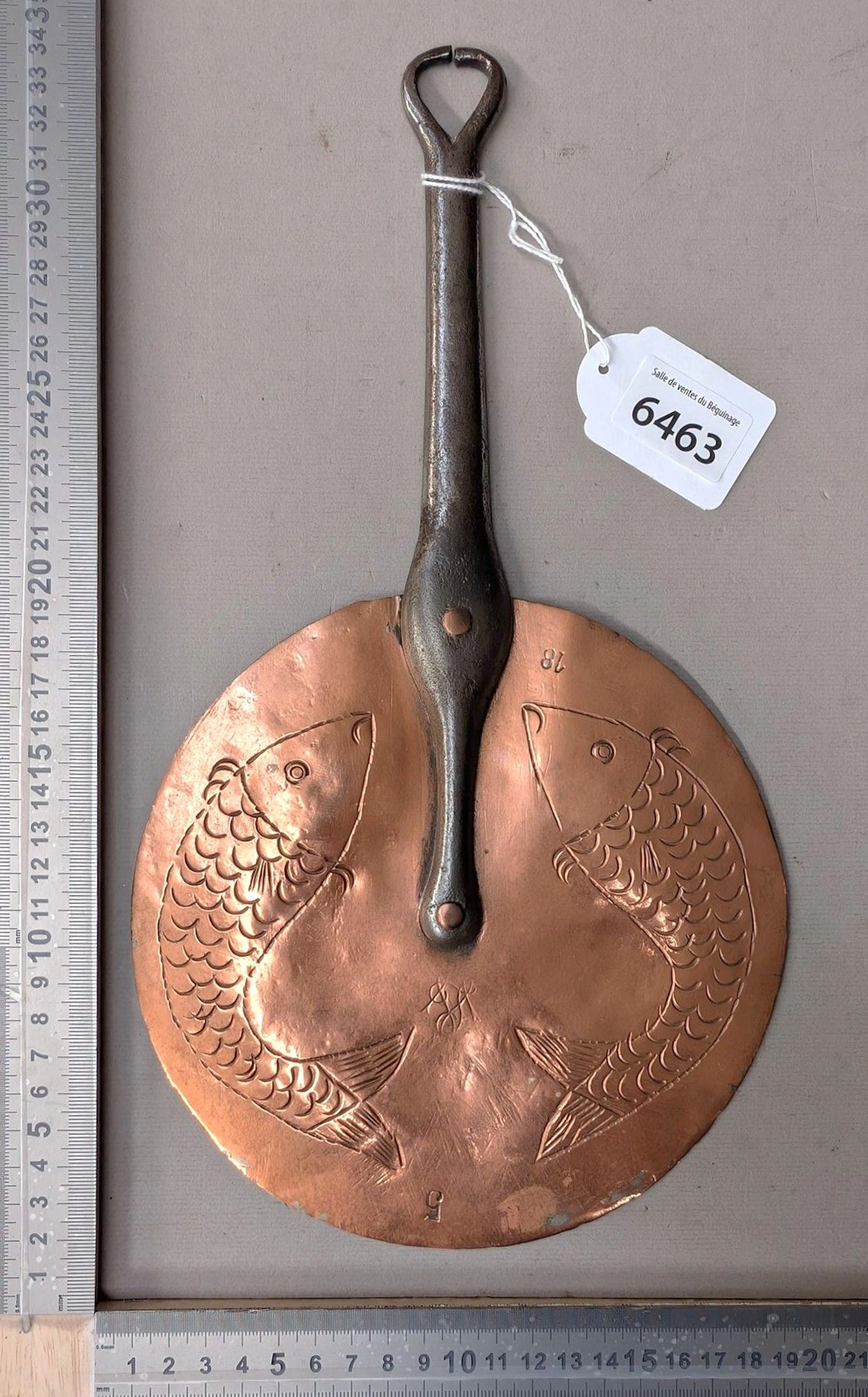 Antique brass lid with a wrought-iron handle riveted with copper