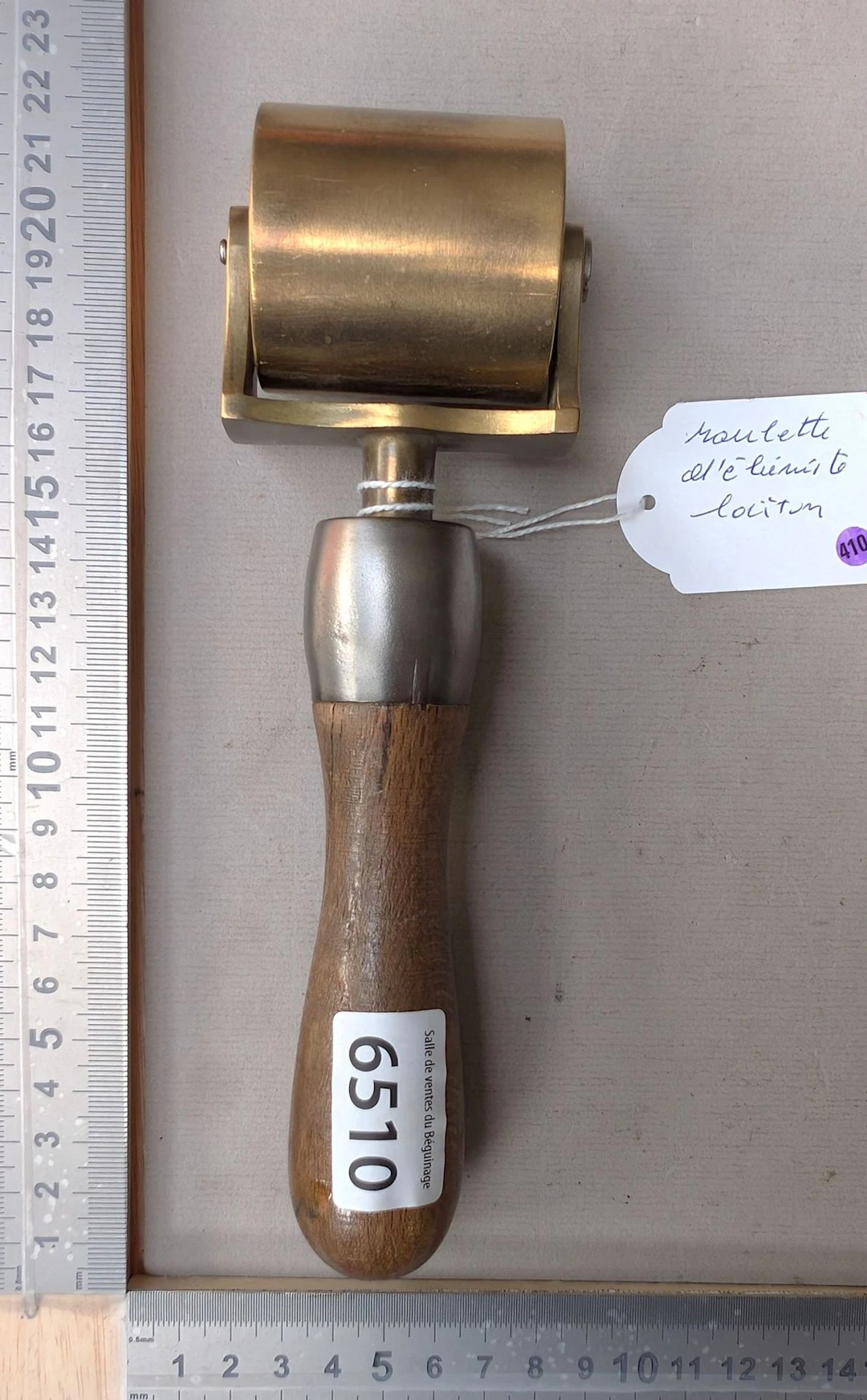 1 brass cabinetmaker's caster with a wooden handle—see photos for
