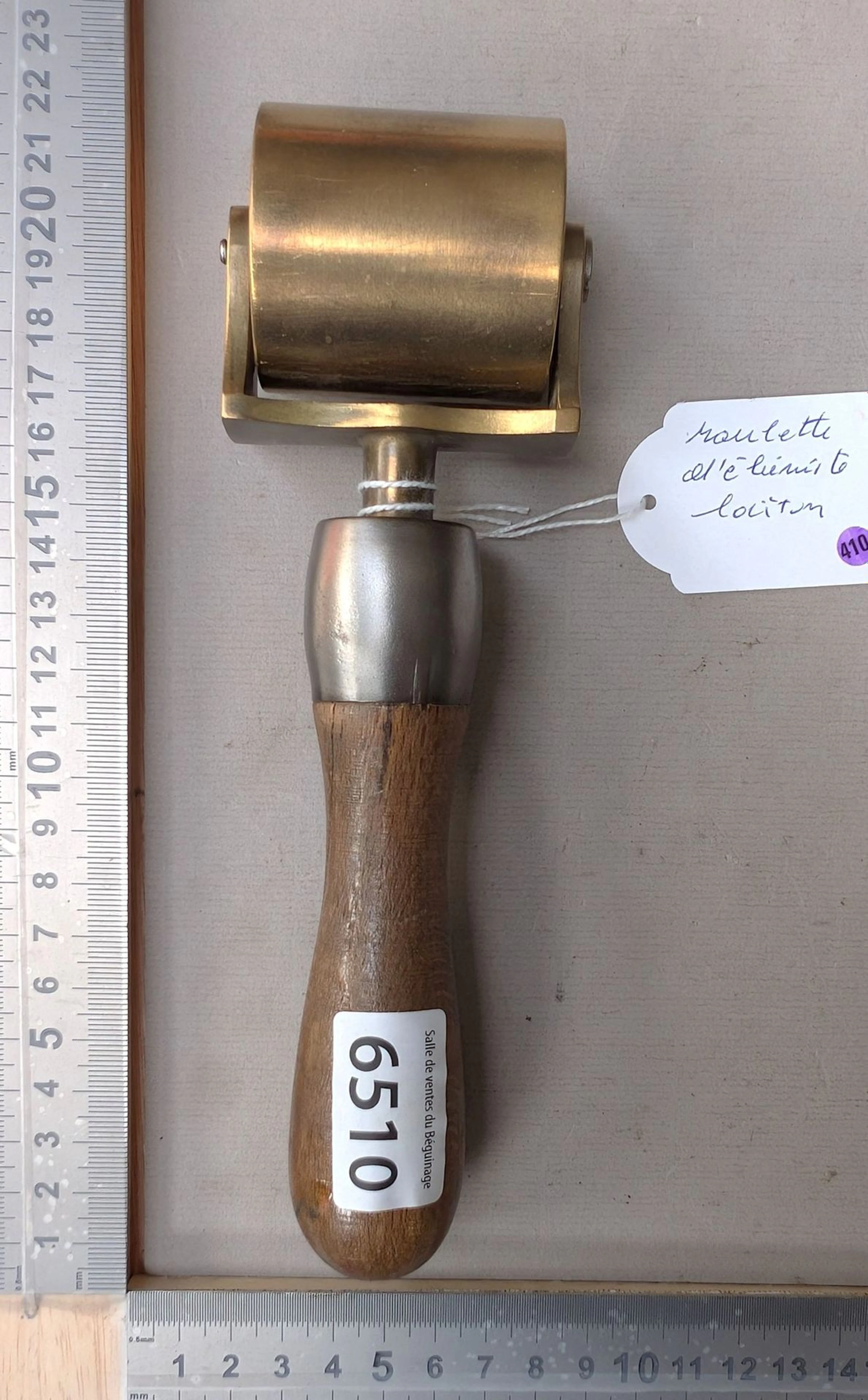 1 brass cabinetmaker's caster with a wooden handle—see photos for