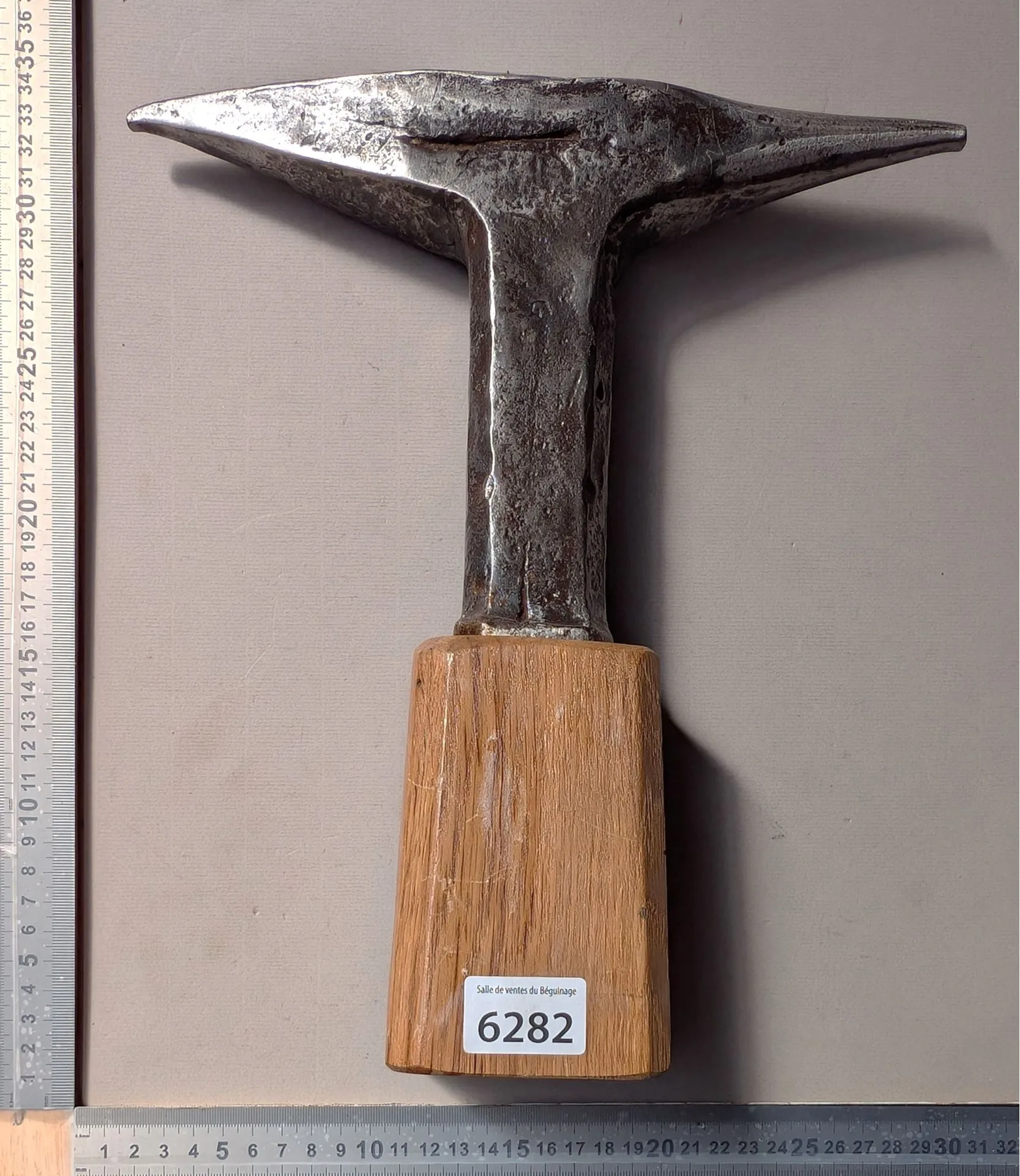 1 wrought-iron anvil on an oak base—see photos for dimensions and condition