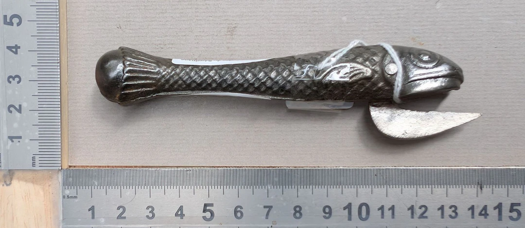 1 antique cast-iron can opener shaped like a fish—see photos for dimensions