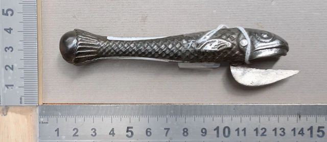 1 antique cast-iron can opener shaped like a fish—see photos for dimensions