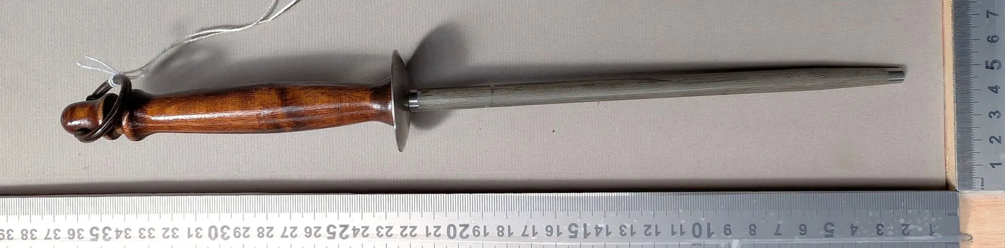 Antique butcher's sharpening knife with wooden handle, 20th century—see